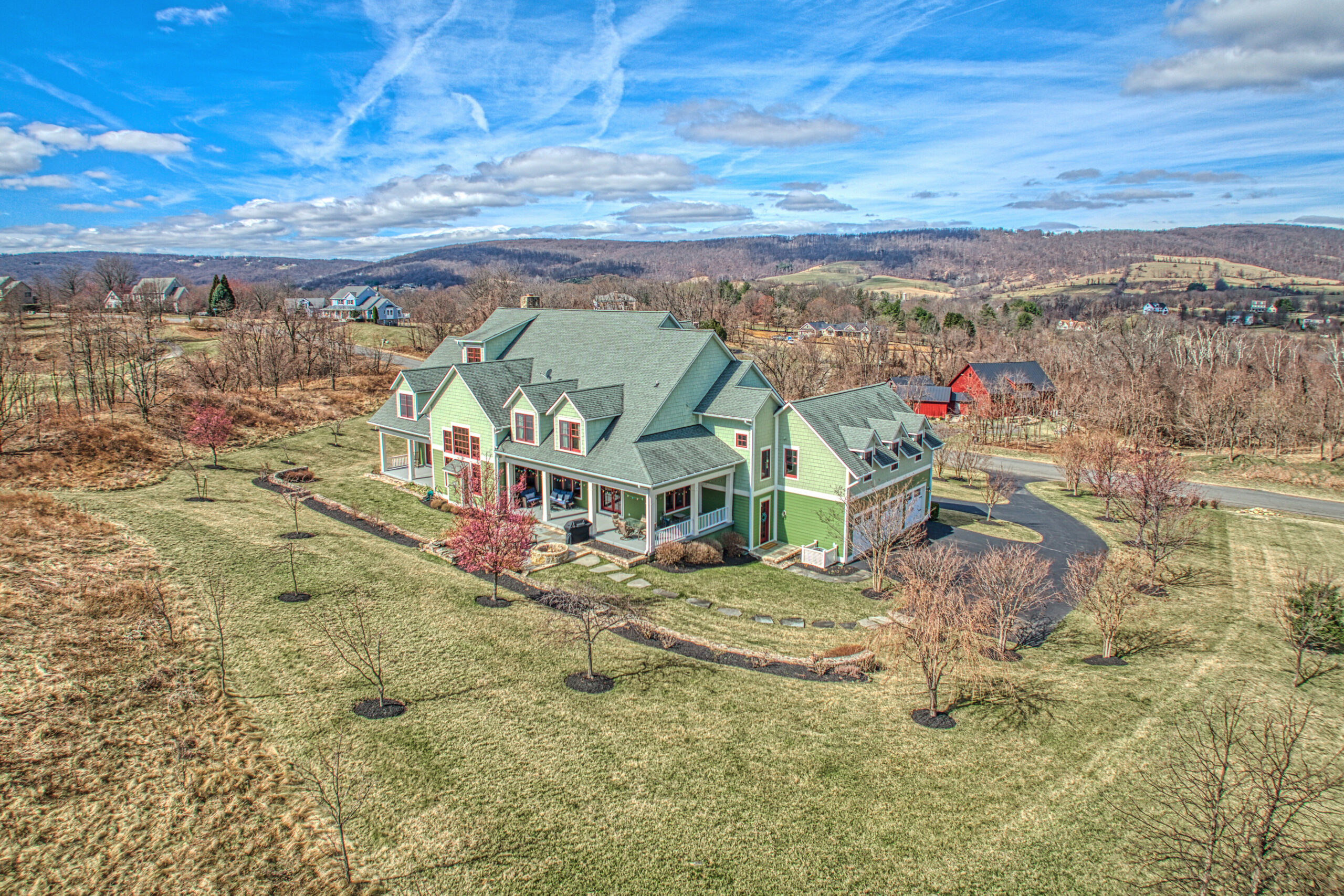 drone photo of beautiful green home on large property in Round Hill, Virginia