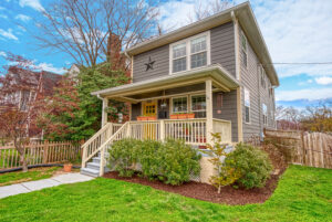 single family home with full front porch and yellow door, corner lot in NW Washington DC
