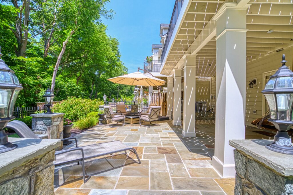 Beautiful stone patio behind an end unit townhome on a sunny day
