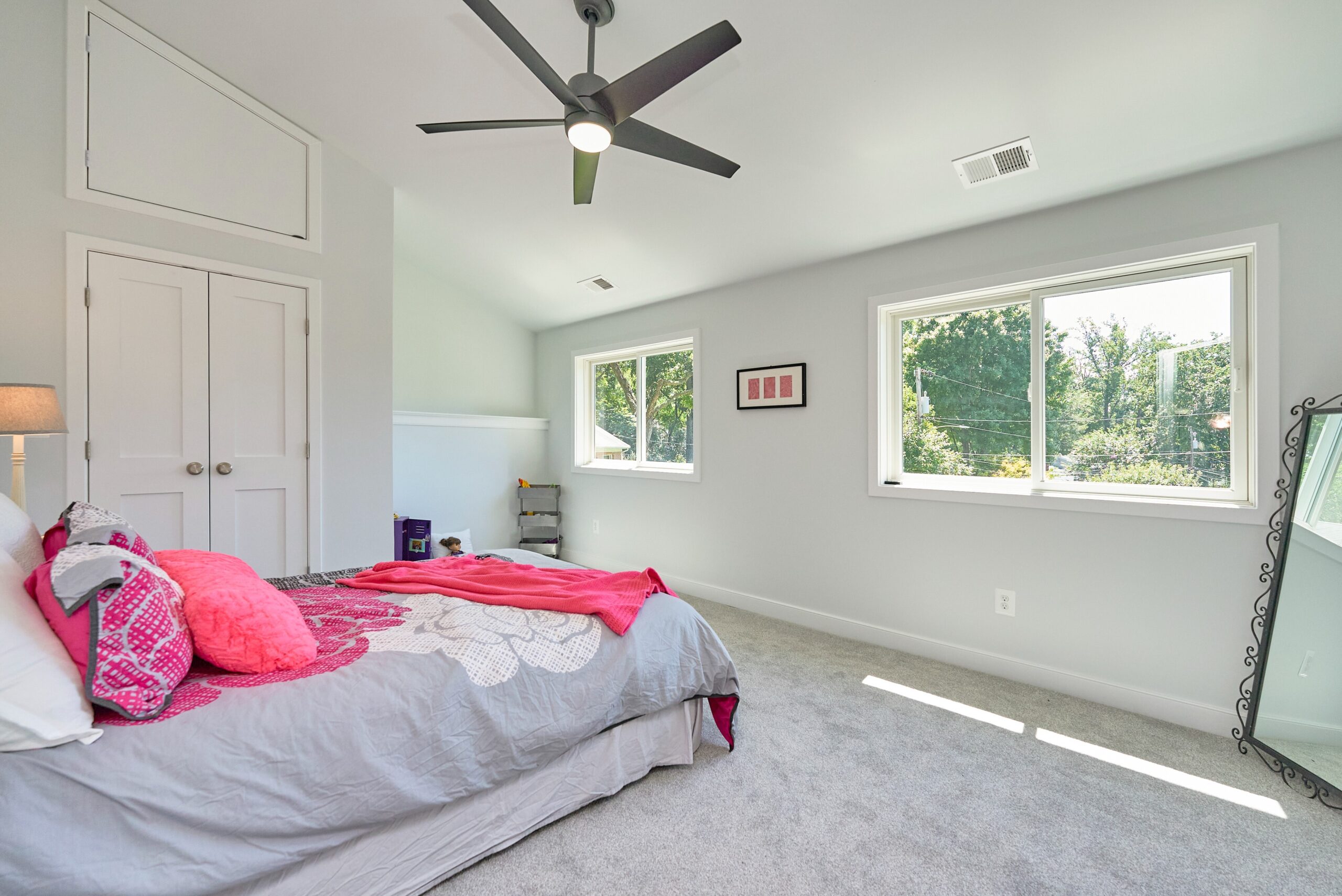 Professional photo of interior of custom home in Falls Church, Virginia. Shows a bedroom with a high angled, vaulted ceiling, ceiling fan, and nook.