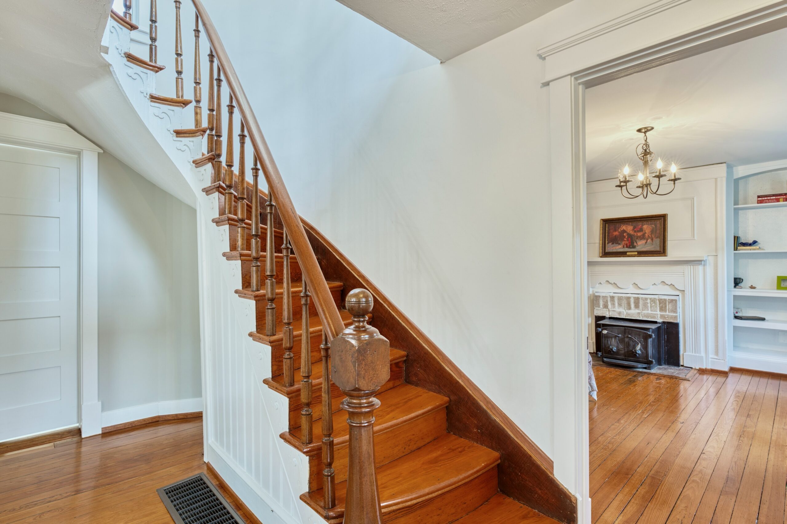 Dramatic staircase inside the front door of historic home in Hamilton, VA with hardwood floors
