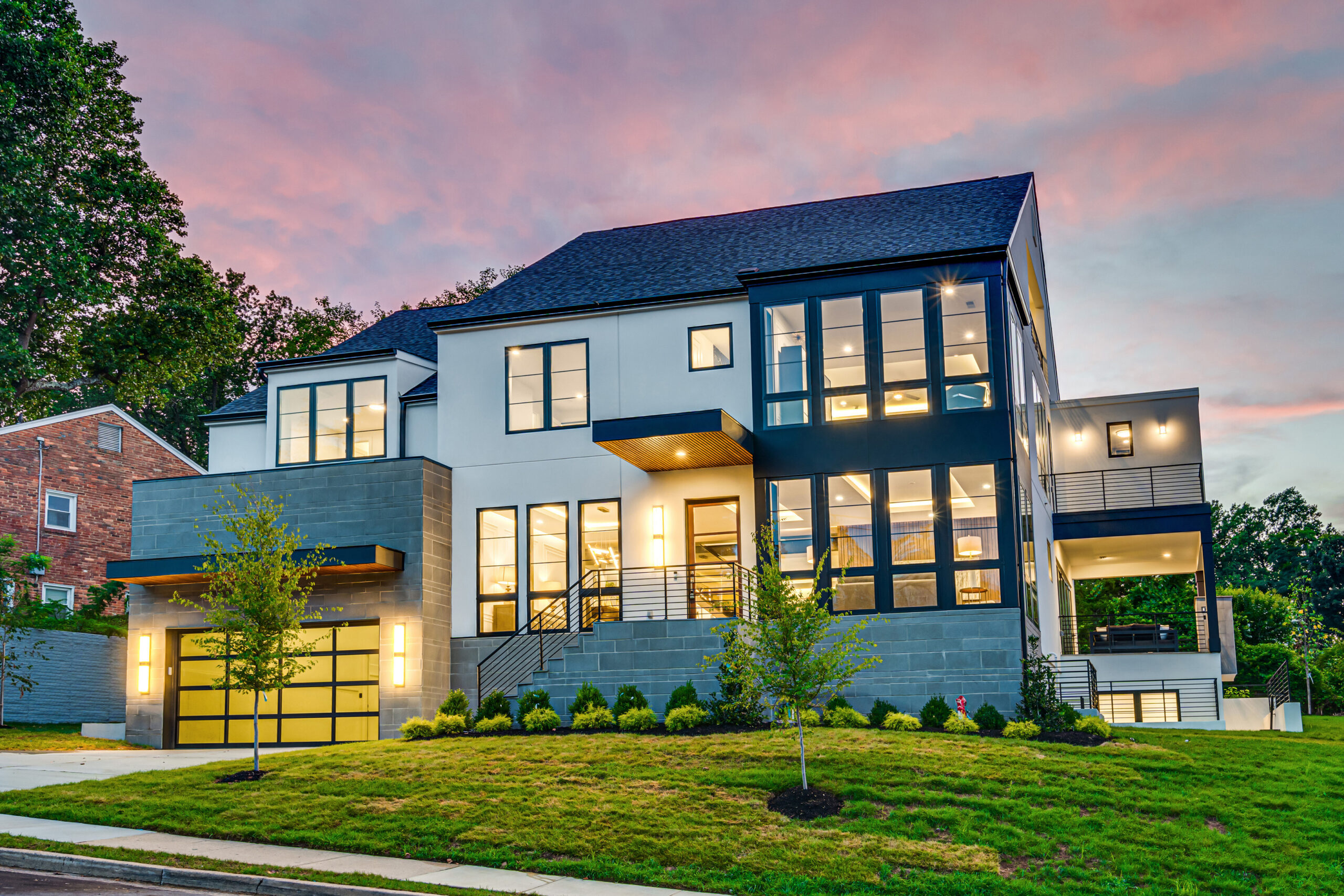 front exterior of a modern new construction home at dusk in arlington virginia