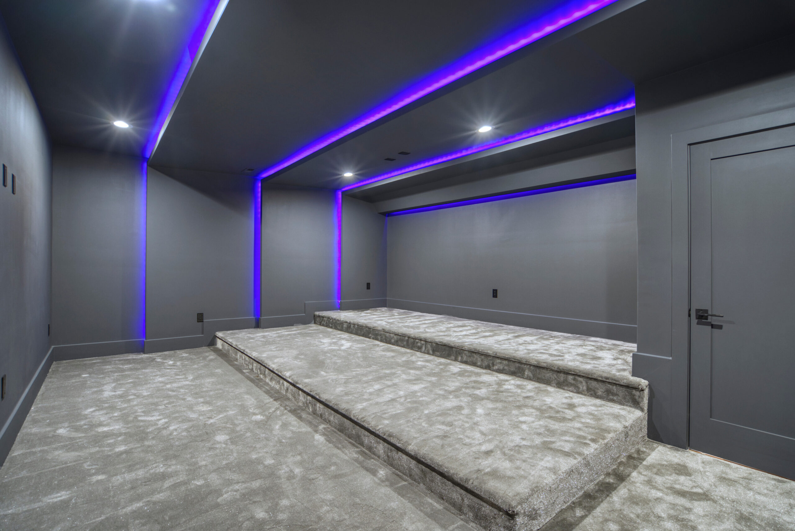 cinema/media room with 3 levels and LED purple lighting