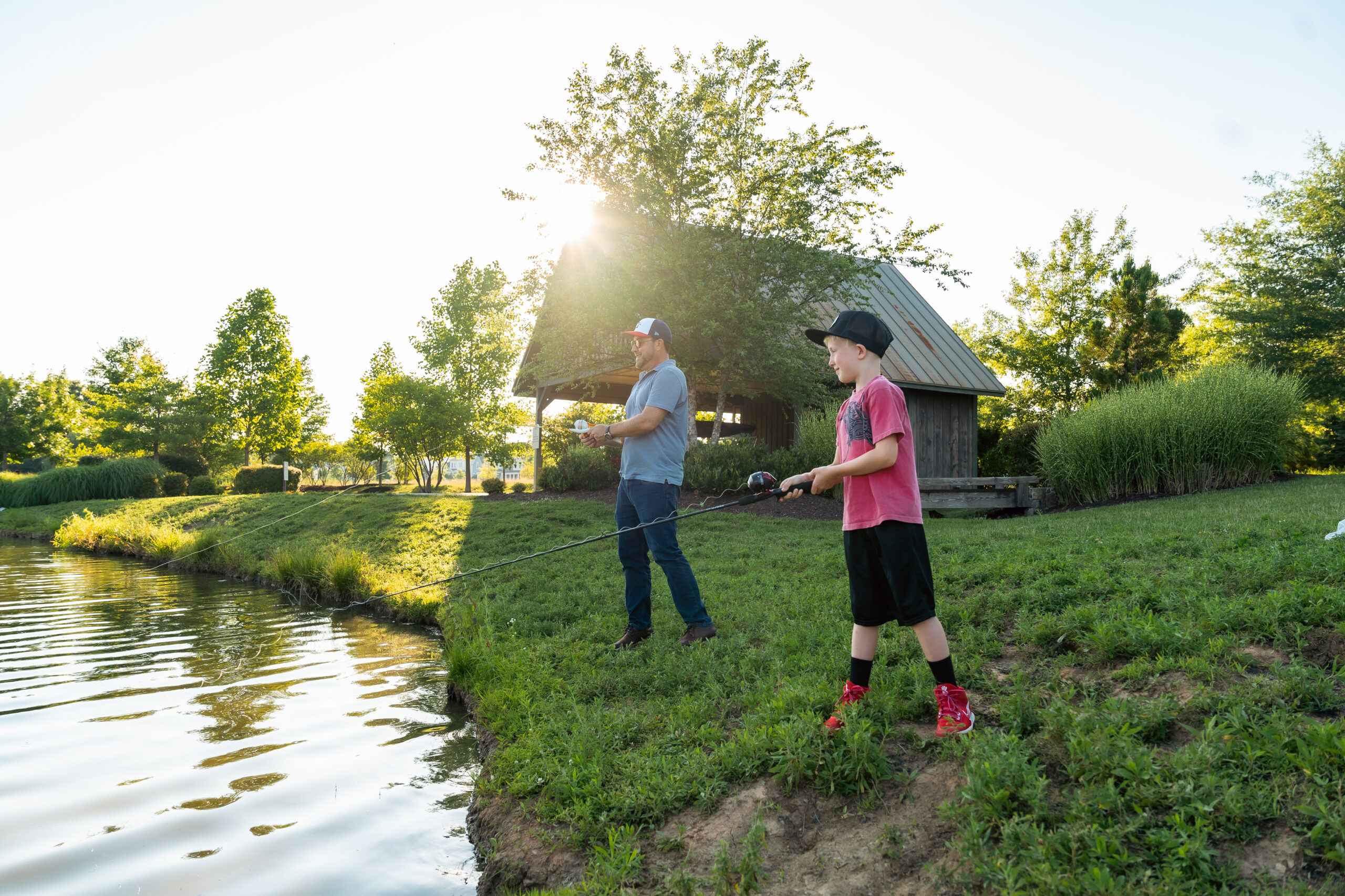 personal branding photo for realtors showing a male realtor going fishing with his son in a community park
