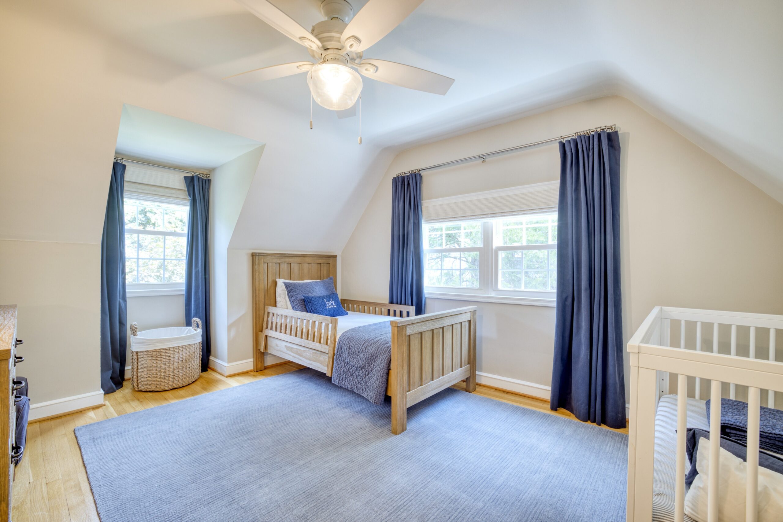 Interior professional photo of child's bedroom of 1946 Cape Cod home in Alexandria, VA with neutral blue staging