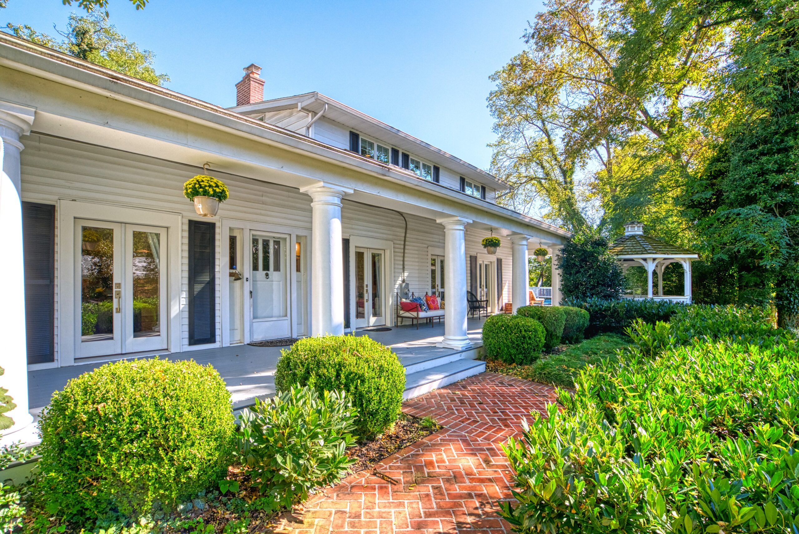 Exterior professional photo of 1826 Varnum St NW - showing a brick path leading to the front porch with thick white columns