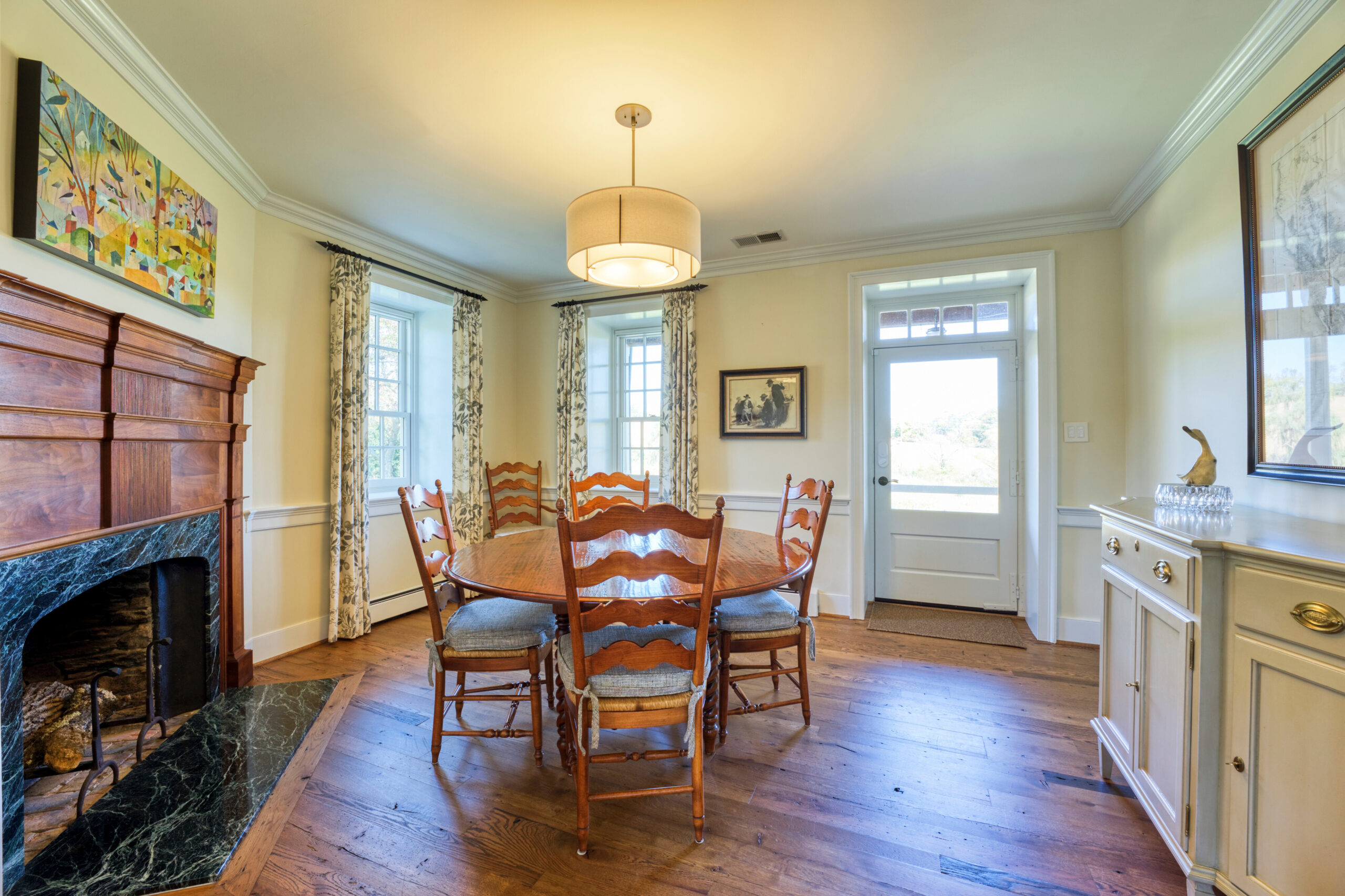 Professional interior photo of main house of Historic Hearthstone Manor: 35428 Appalachian Trail Rd, Round Hill, Virginia - showing formal breakfast room with wooden dining set and fireplace
