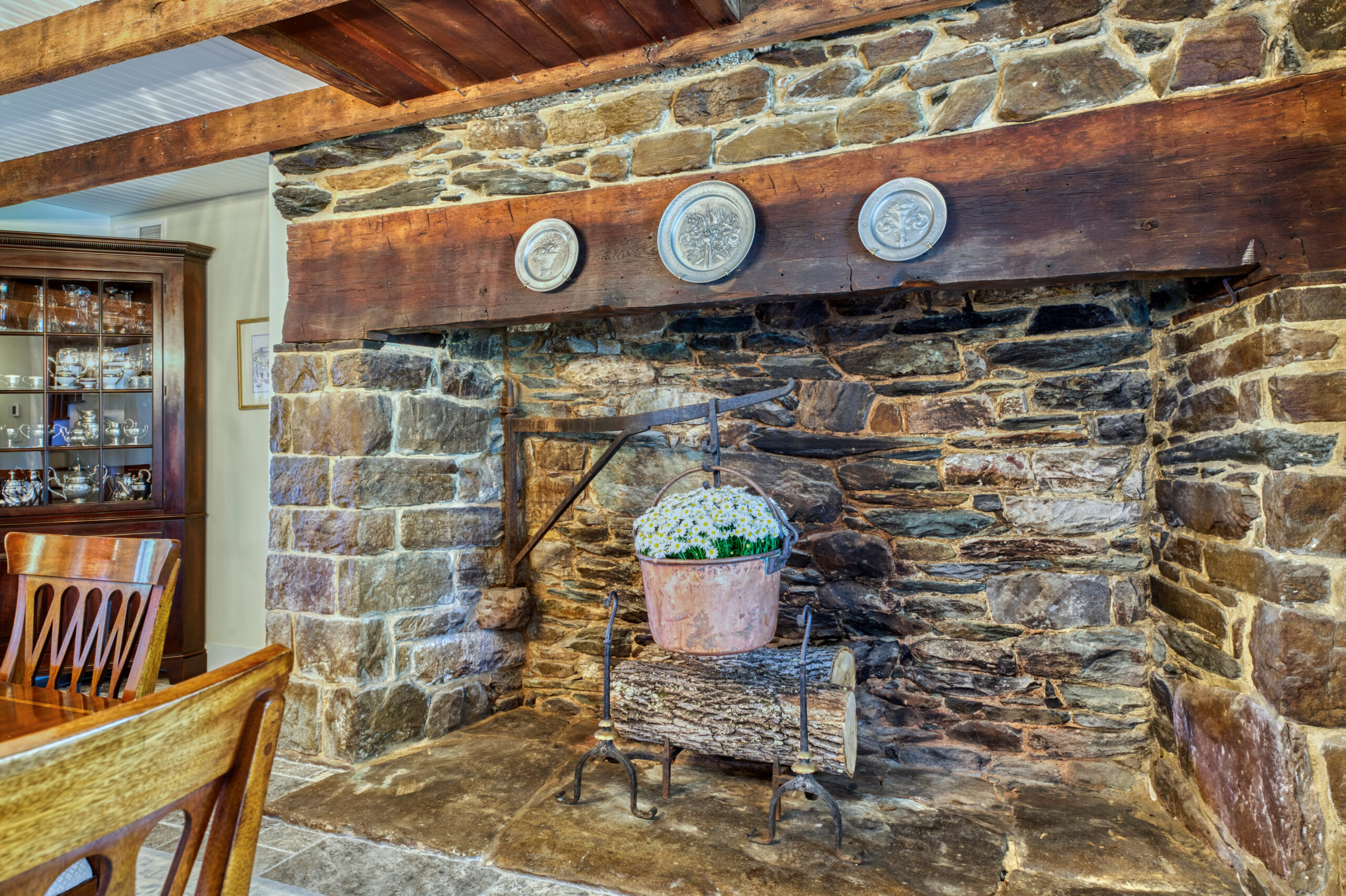 Professional interior photo of main house of Historic Hearthstone Manor: 35428 Appalachian Trail Rd, Round Hill, Virginia - showing huge stone fireplace in formal dining room