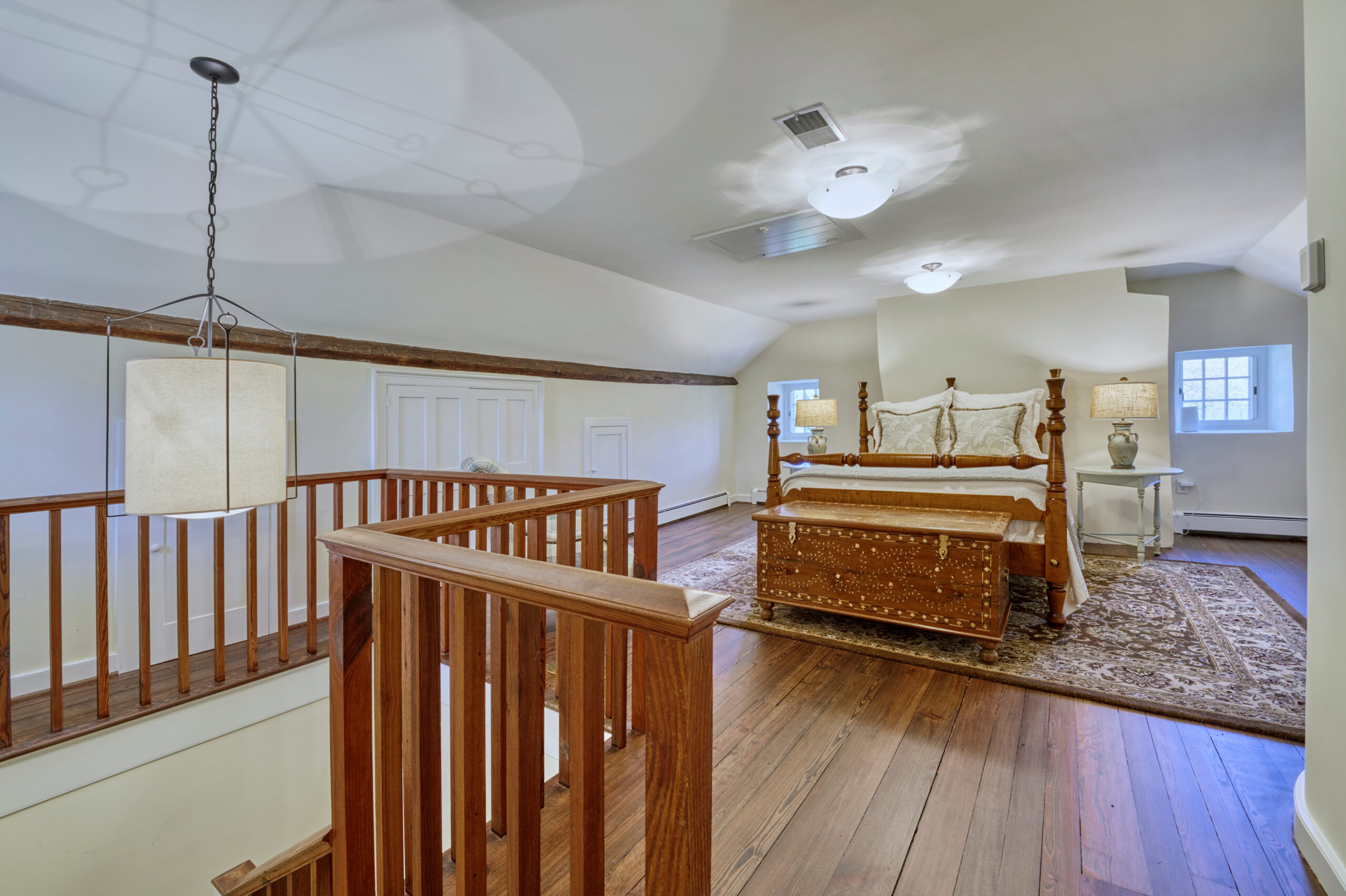 Professional interior photo of main house of Historic Hearthstone Manor: 35428 Appalachian Trail Rd, Round Hill, Virginia - showing loft bedroom with hardwood floors and 4-poster bed