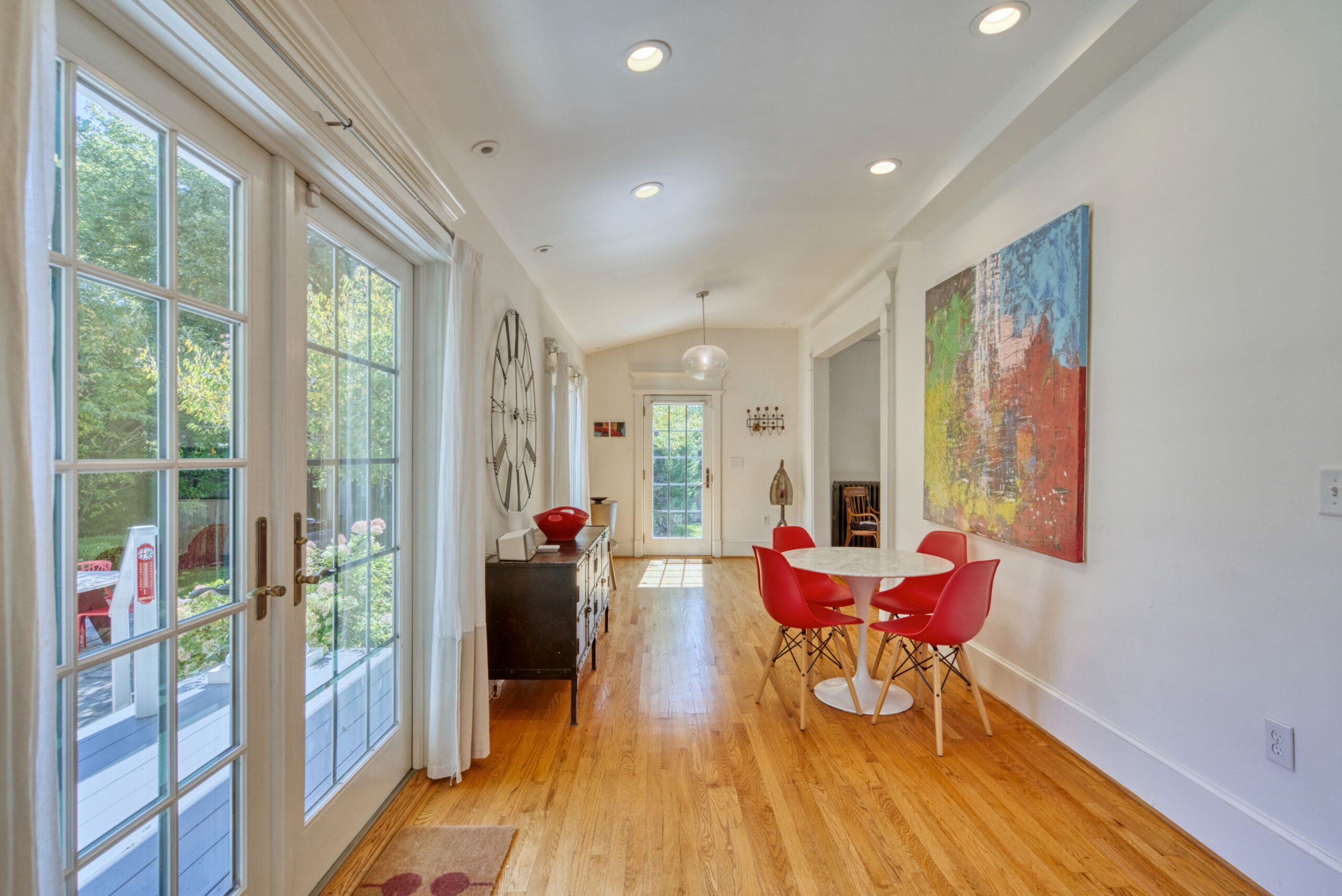 Interior professional photo of 1826 Varnum St NW - showing a bistro table on hardwood floors in a wide hallway at the back of the home