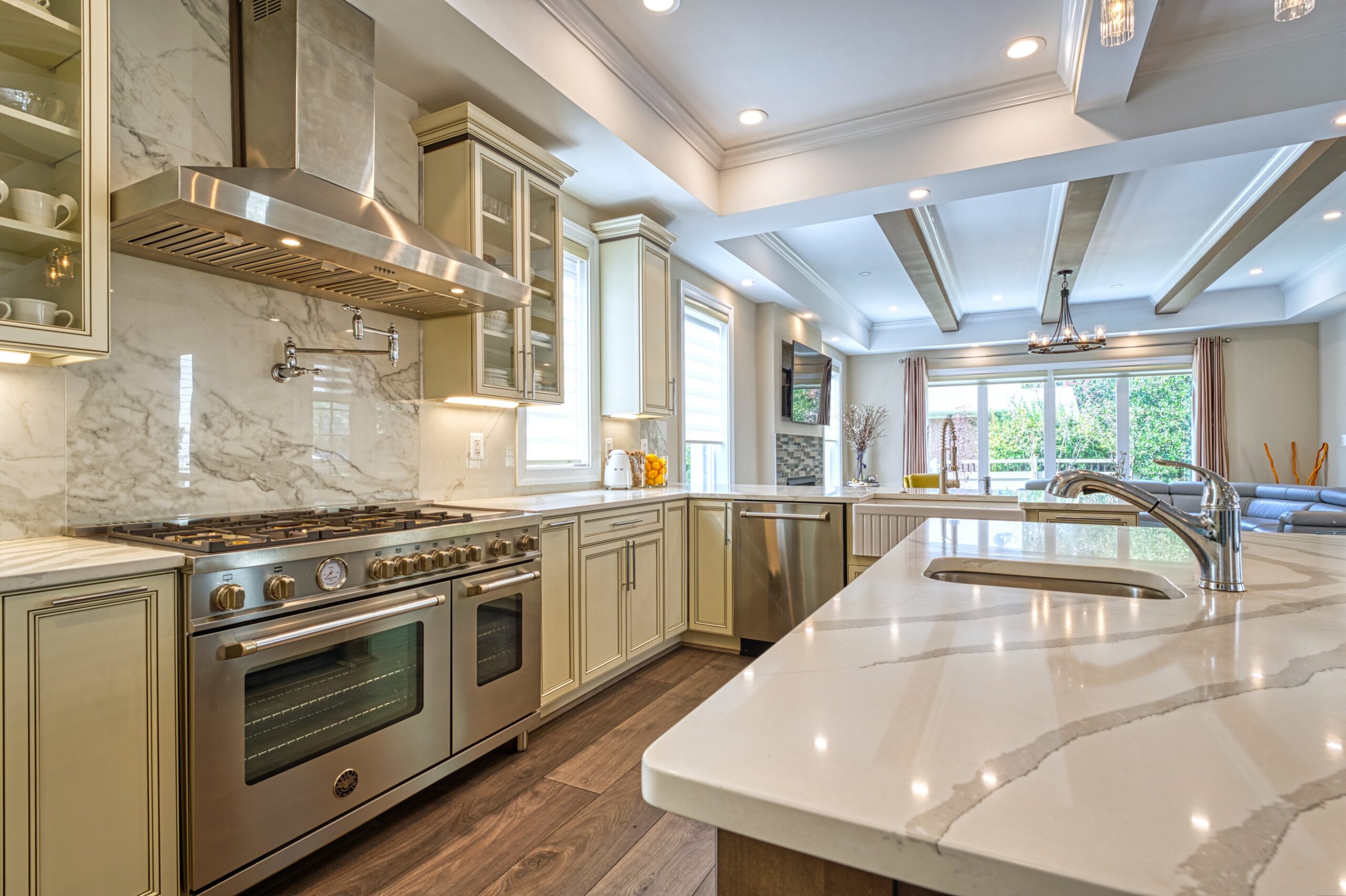 professional Fusion photo of the interior of a home in McLean, VA - showing gourmet kitchen with intricate coffered ceiling, huge counter, stainless hood/range and large kitchen island with quartz countertops