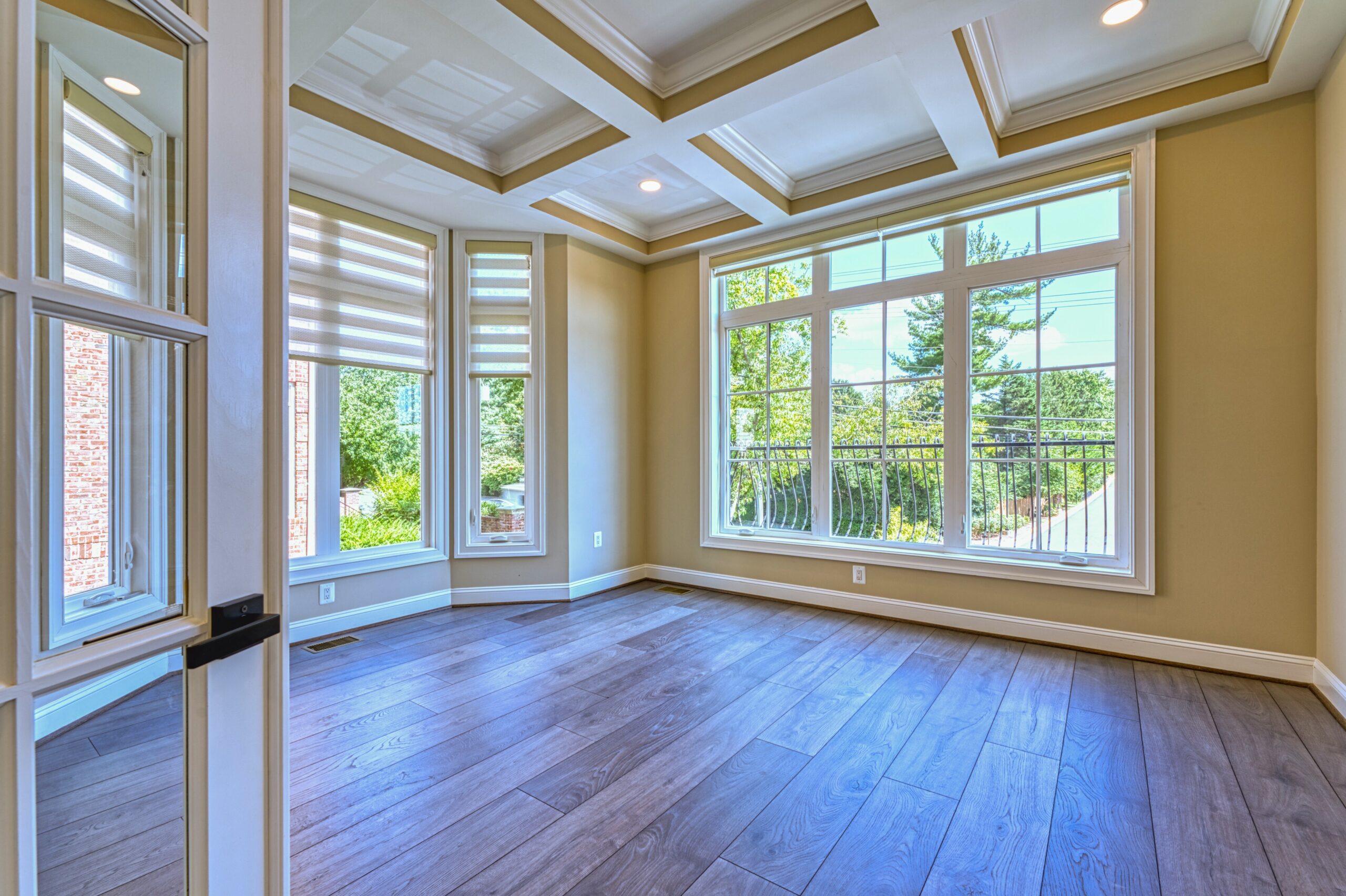 professional Fusion photo of the interior of a home in McLean, VA - showing sunroom/formal sitting room (empty) with deep coffered ceiling