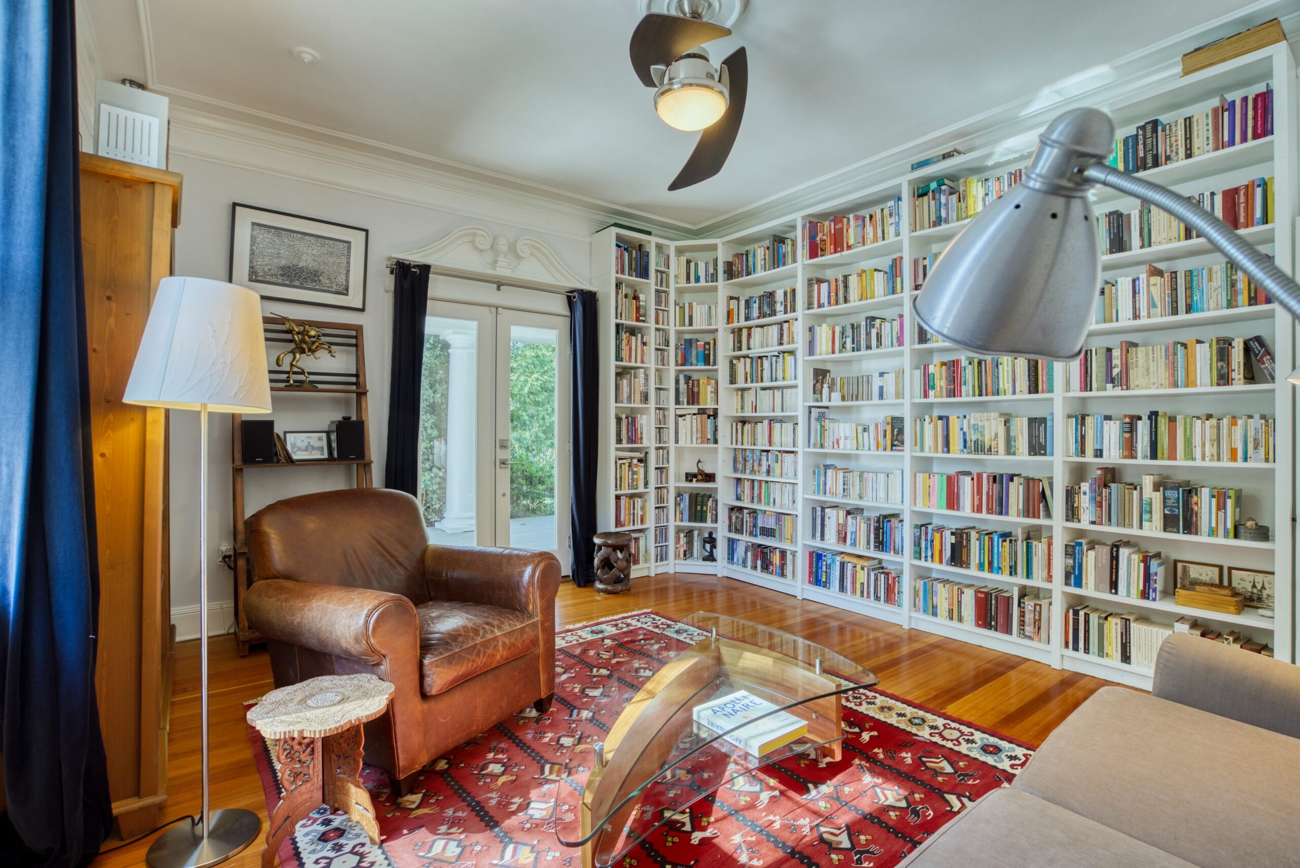 Interior professional photo of 1826 Varnum St NW - showing a study with built-in, floor-to-ceiling bookshelves, hardwood floors