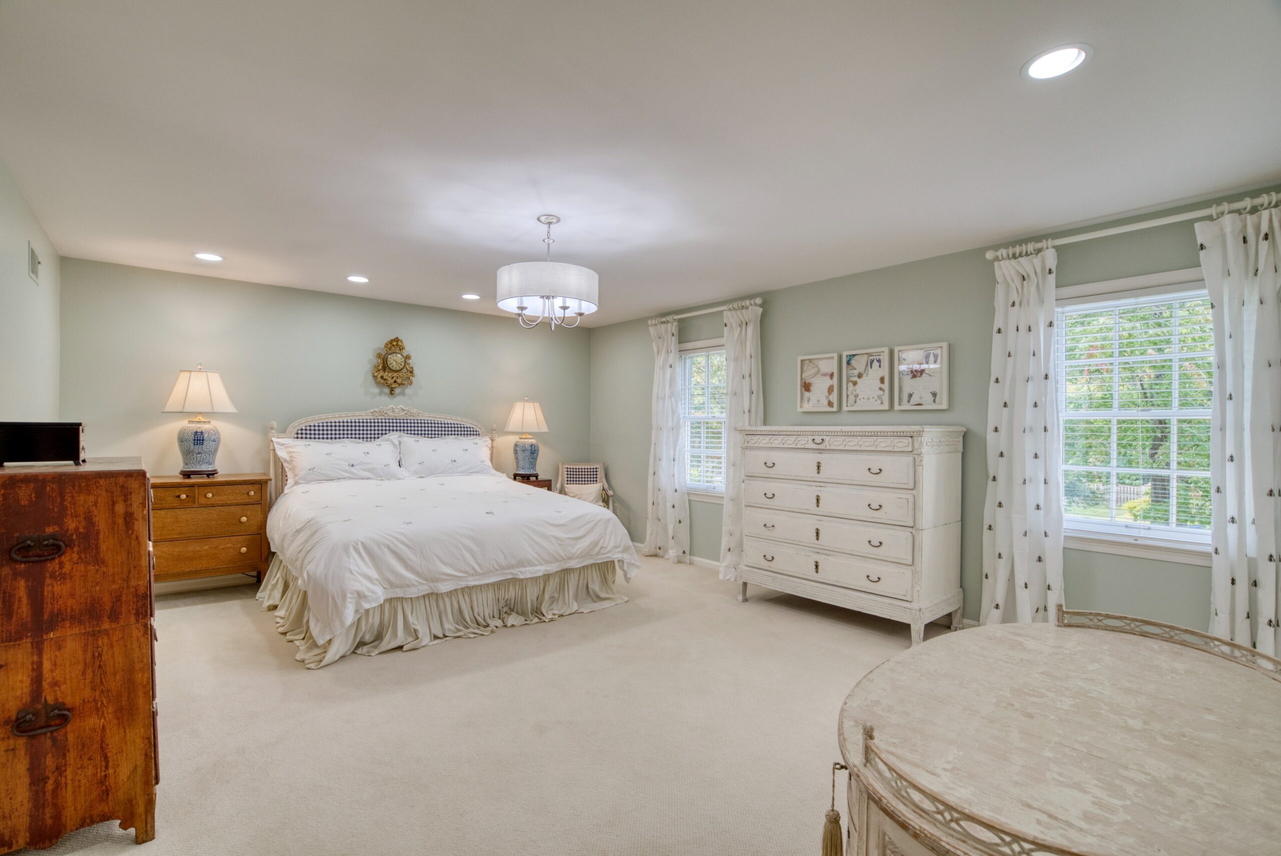 Professional interior photo of 8305 River Falls Dr, Potomac, MD - showing brightly lit master bedroom