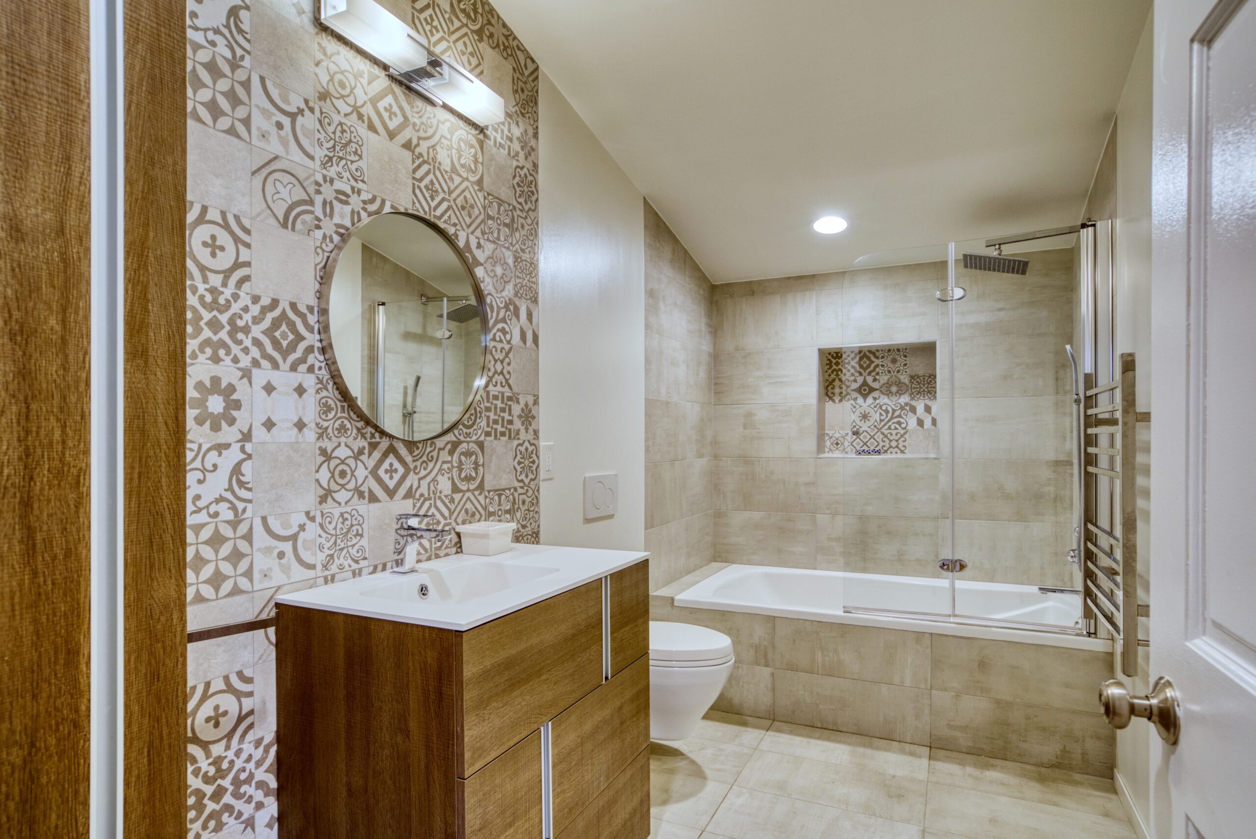 Interior professional photo of 1826 Varnum St NW - showing a bathroom with interesting tilework behind the vanity and in the tub/shower