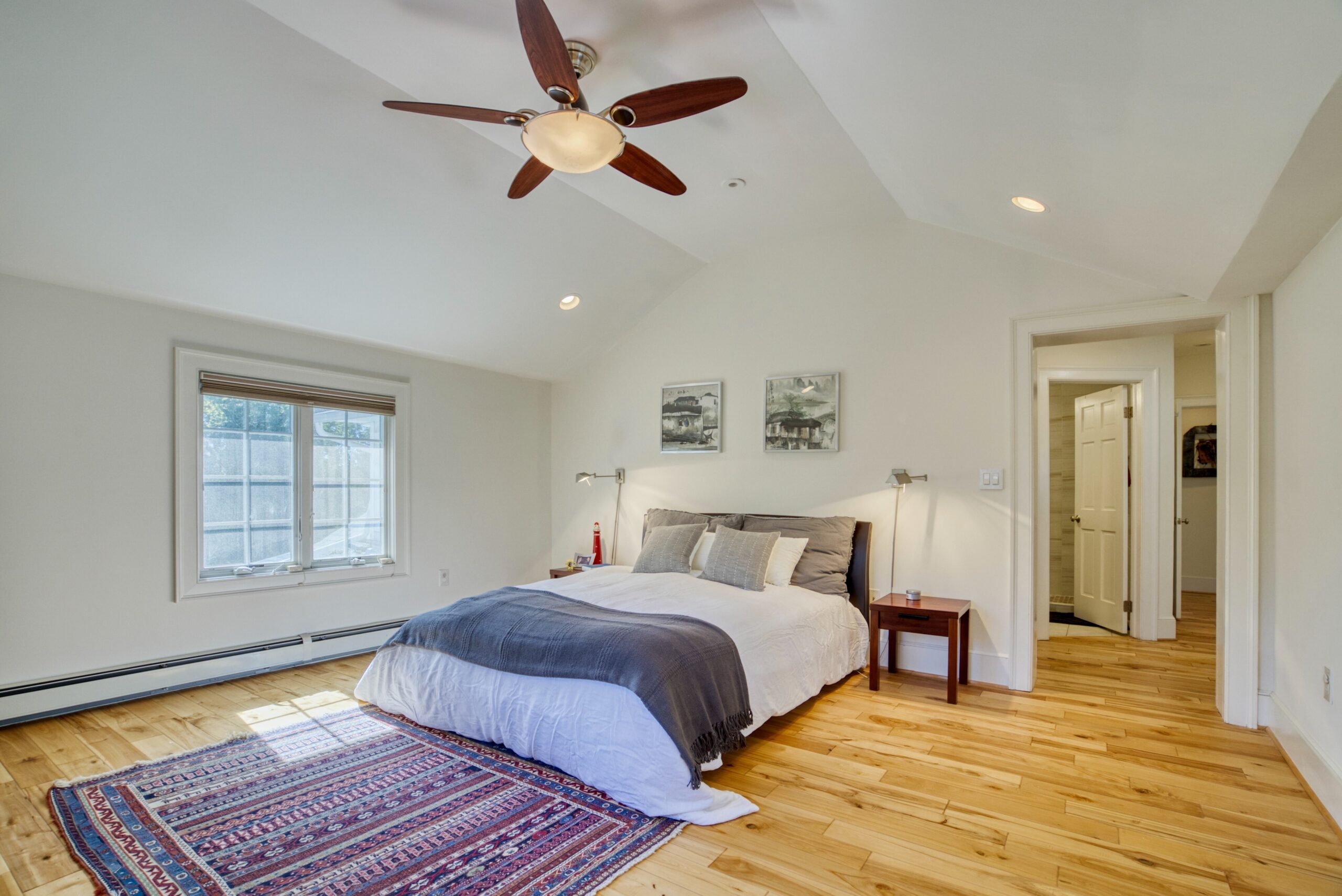 Interior professional photo of 1826 Varnum St NW - showing the master bedroom with cathedral ceiling and hardwood floors