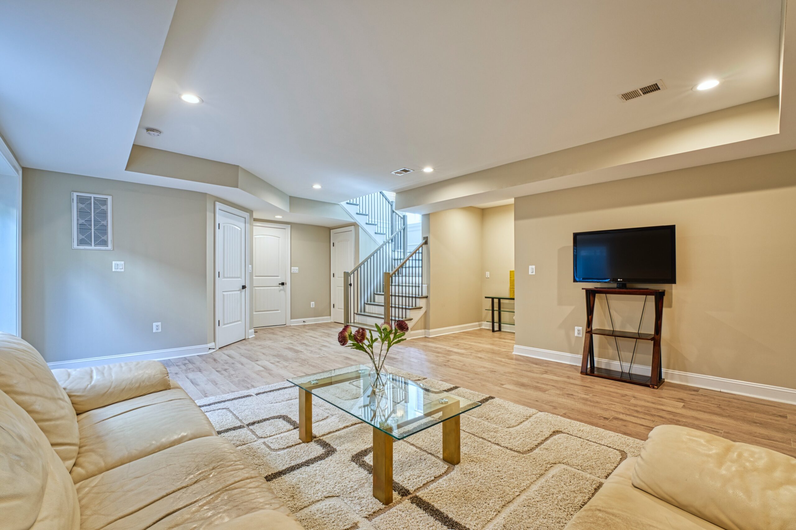 professional Fusion photo of the interior of a home in McLean, VA - showing basement living room with wide tray ceiling