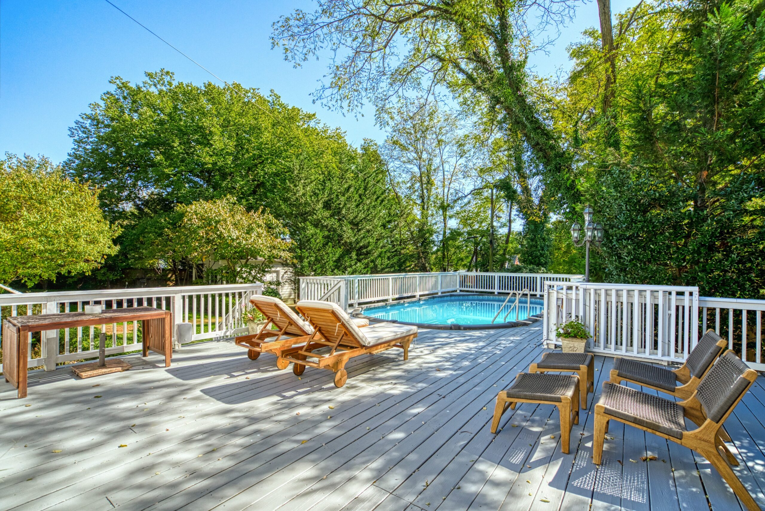 Exterior professional photo of 1826 Varnum St NW - showing the pool deck with lounge chairs and the pool in the background