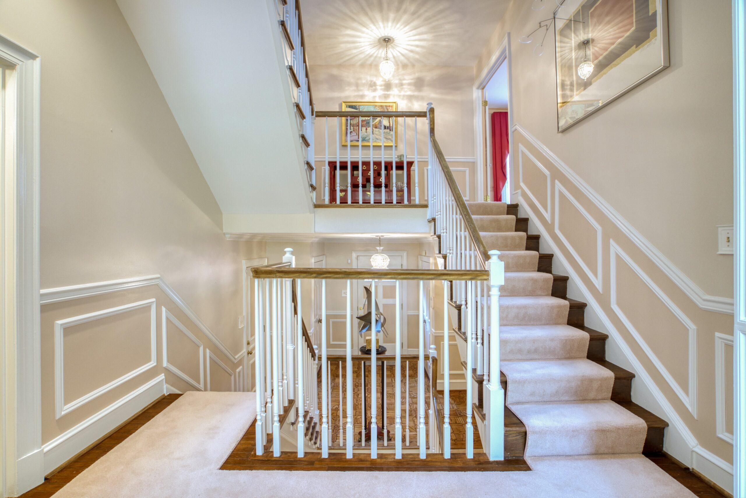 Interior professional photo of 1324 Skipwith Road - showing front entry hall and spiral staircase leading down and up