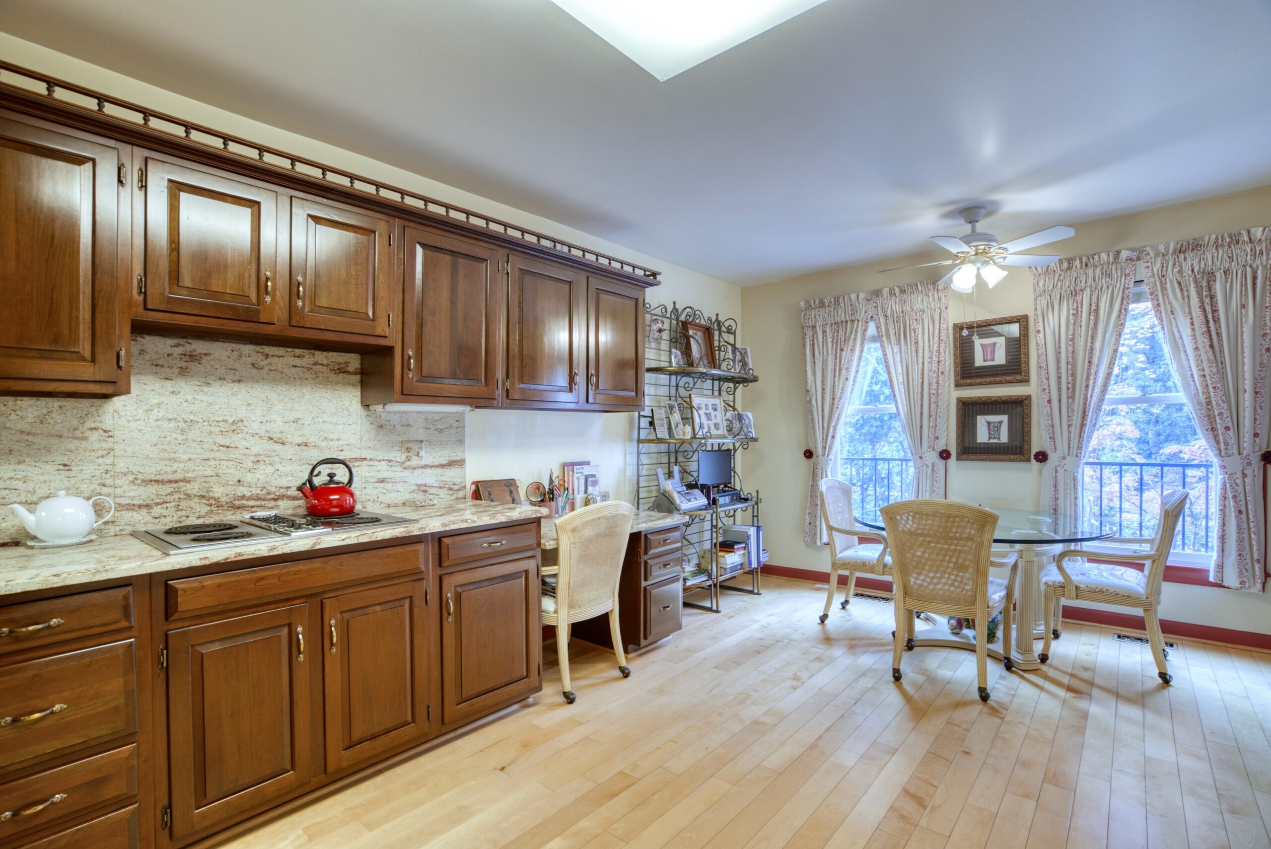 Interior professional photo of 1324 Skipwith Road - showing half of the kitchen with dark wooden cabinets and breakfast table