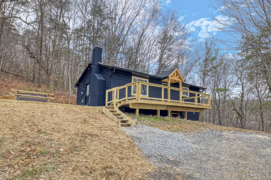Professional exterior photo of 540 Pine Knob Road in Stanley, VA - showing front with large deck and steps