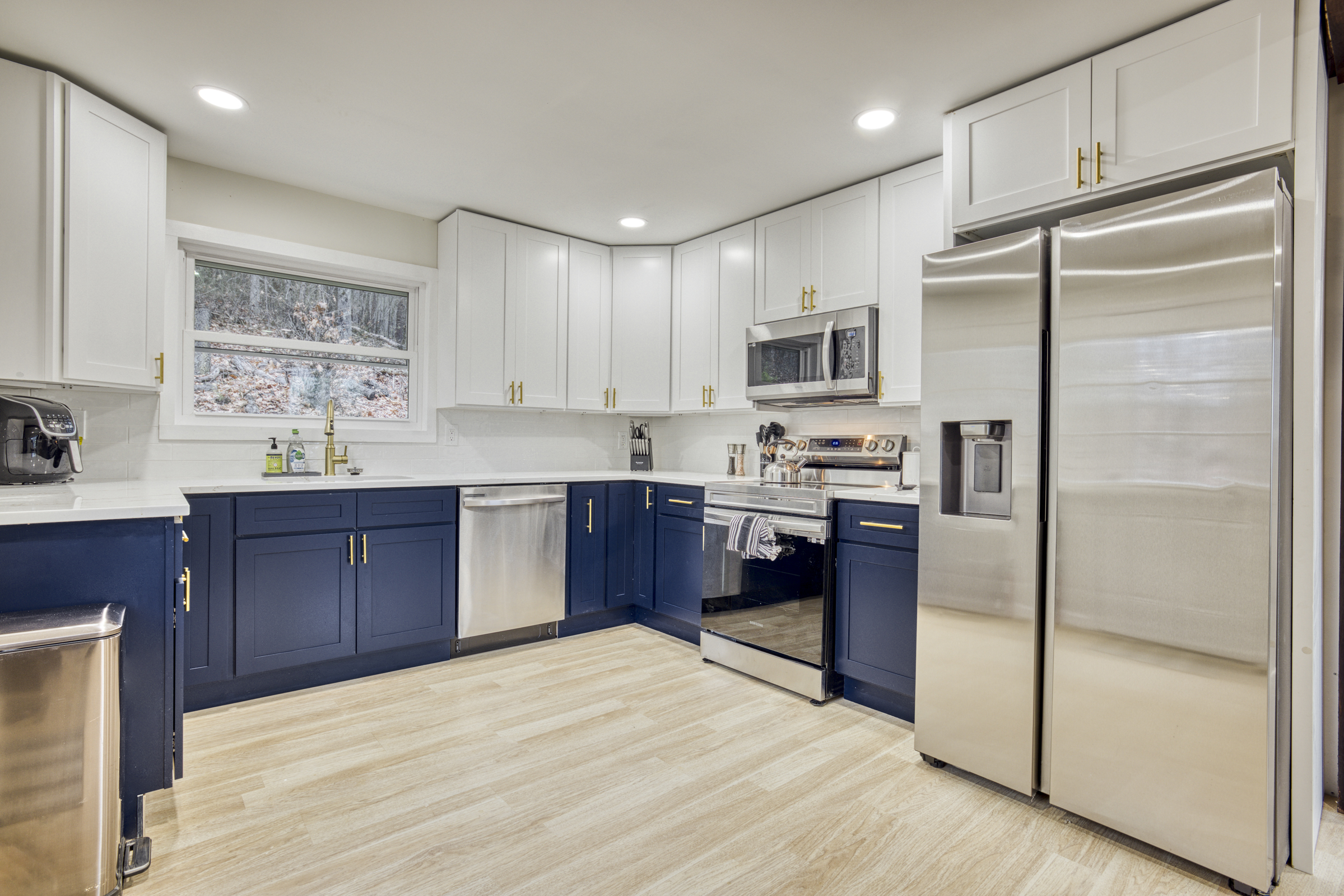 Professional interior photo of 540 Pine Knob Road in Stanley, VA - showing remodeled blue and white kitchen 