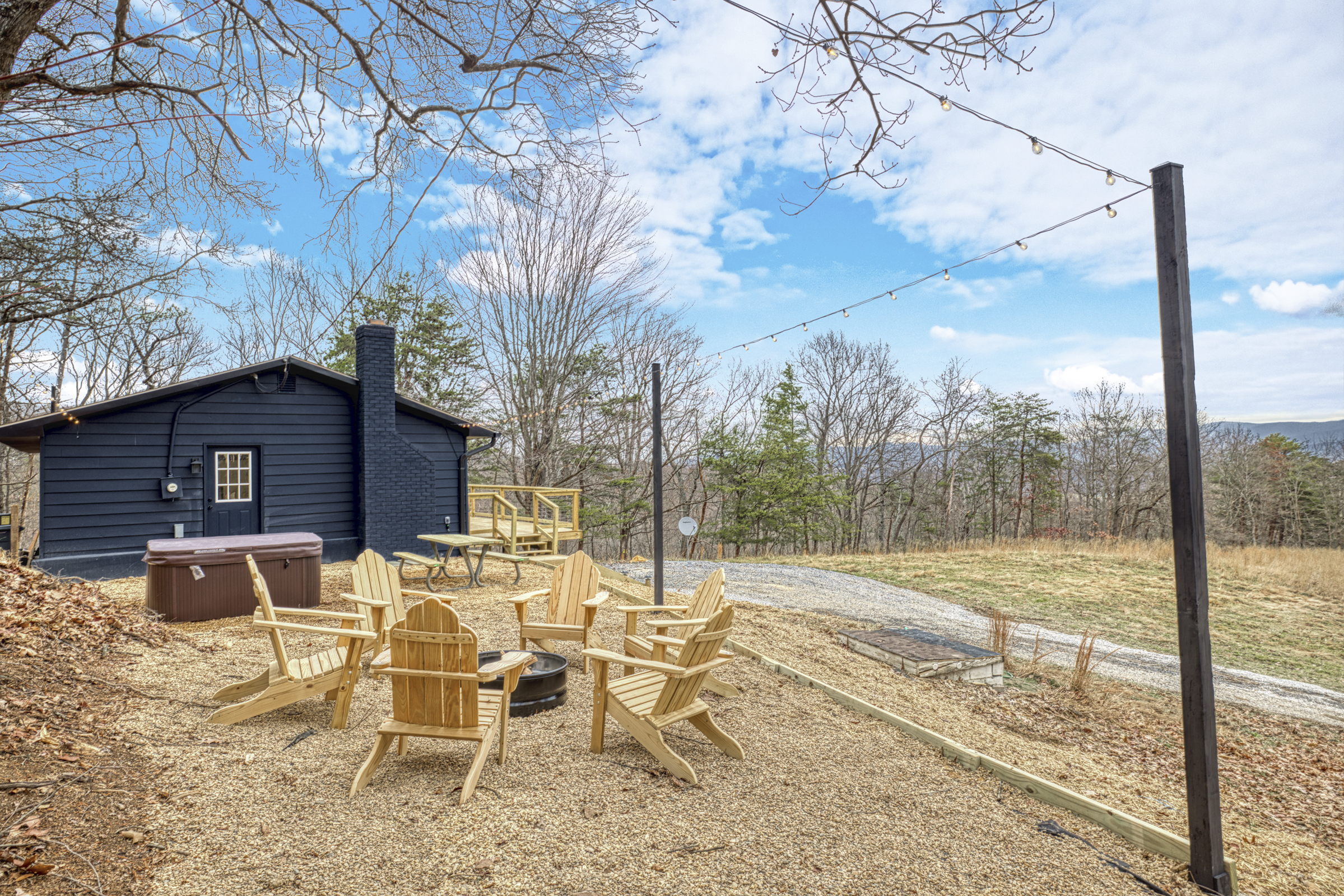Professional exterior photo of 540 Pine Knob Road in Stanley, VA - showing side with fire pit and hot tub