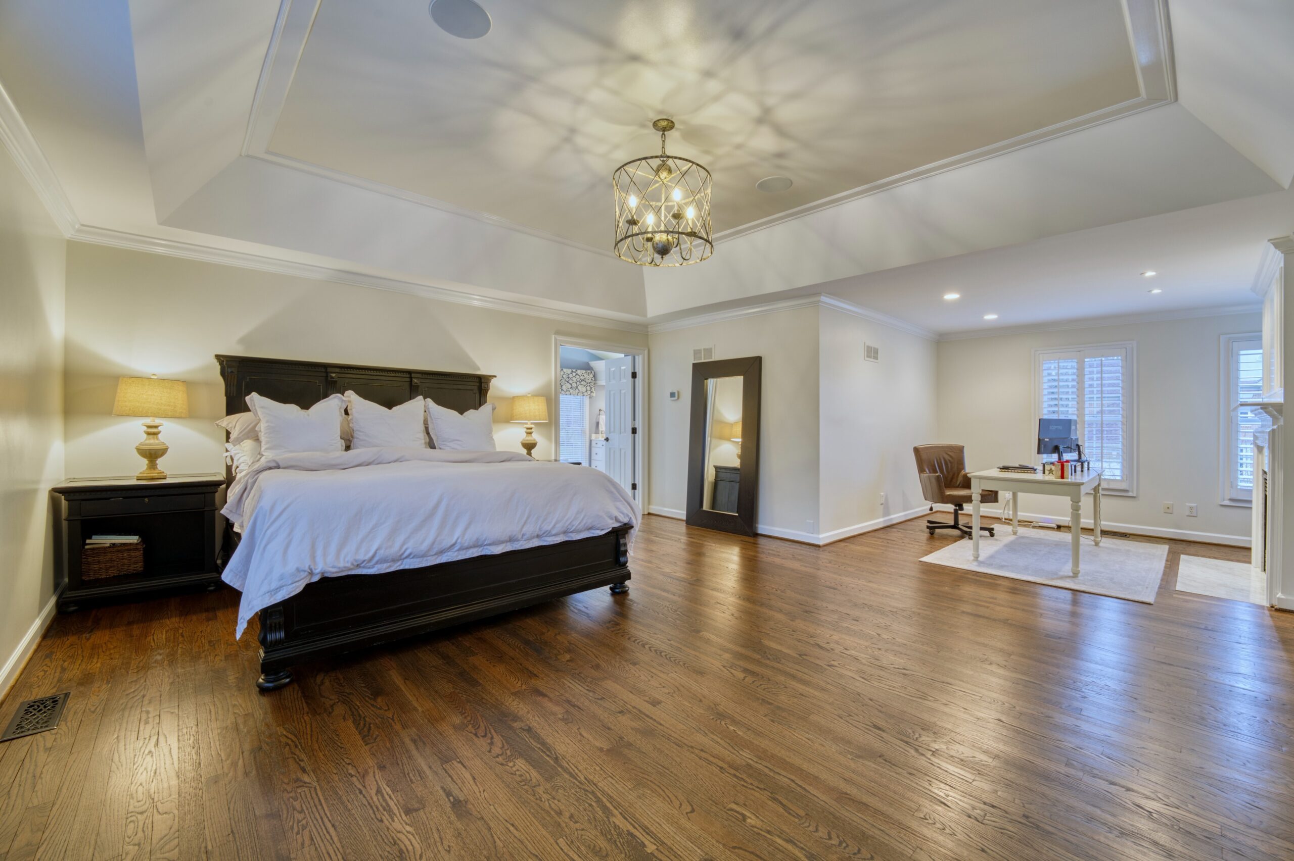 Professional interior photo of 47572 Compton Circle, Sterling, VA - showing the primary bedroom with deep trey ceiling and nook which has been set up as an office