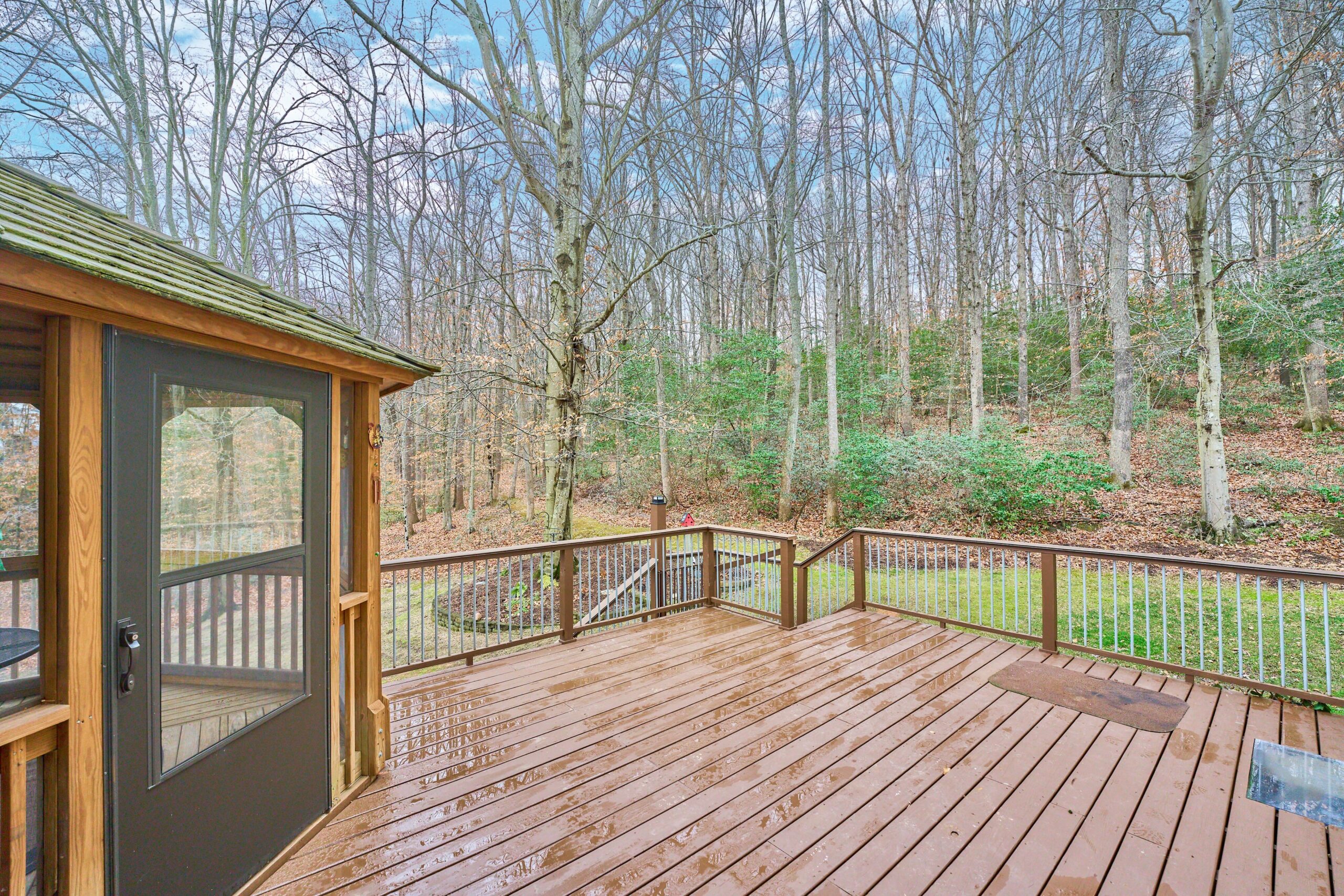 Professional exterior photo of 80 Brentsmill Drive in Stafford, Virginia - showing the rear deck looking out to the right into the woods