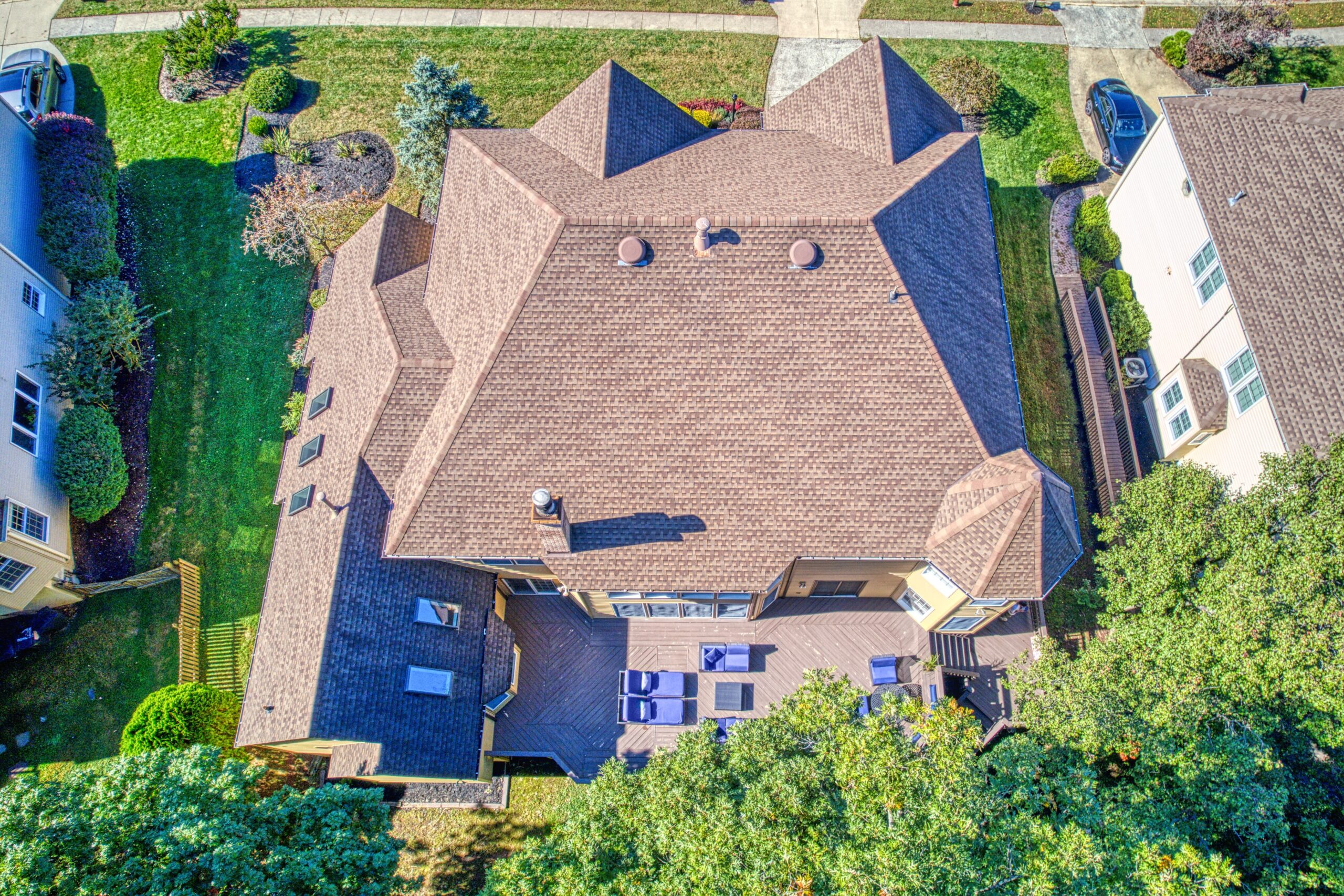Aerial exterior photo of 21024 Starflower Way in Ashburn, VA - showing the entire home from directly above, looking down at the deck with a variety of deck furniture