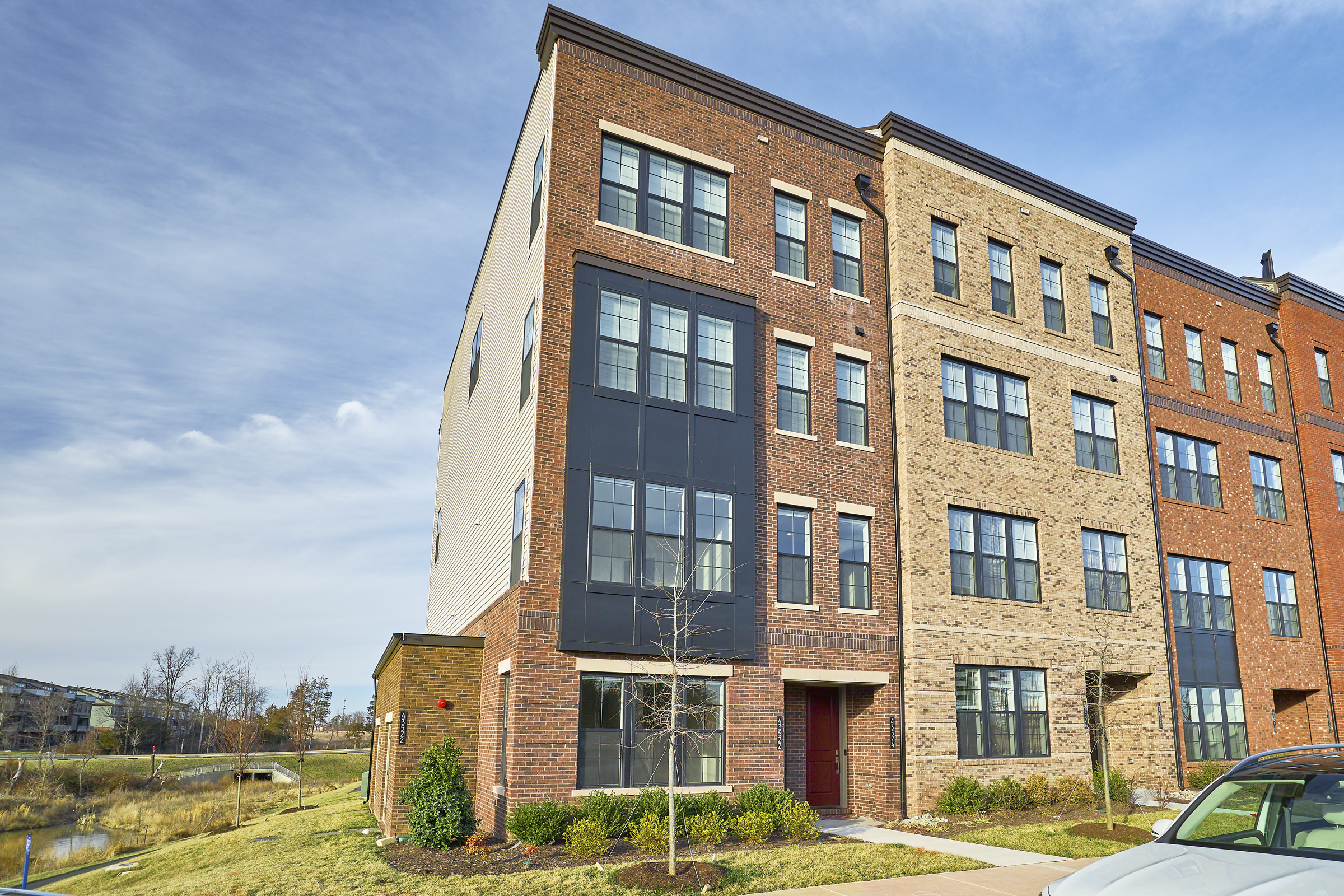 Exterior professional photo of 43522 Centergate Drive - showing the front from the left angle, brick front facade with 4 floors and lots of windows