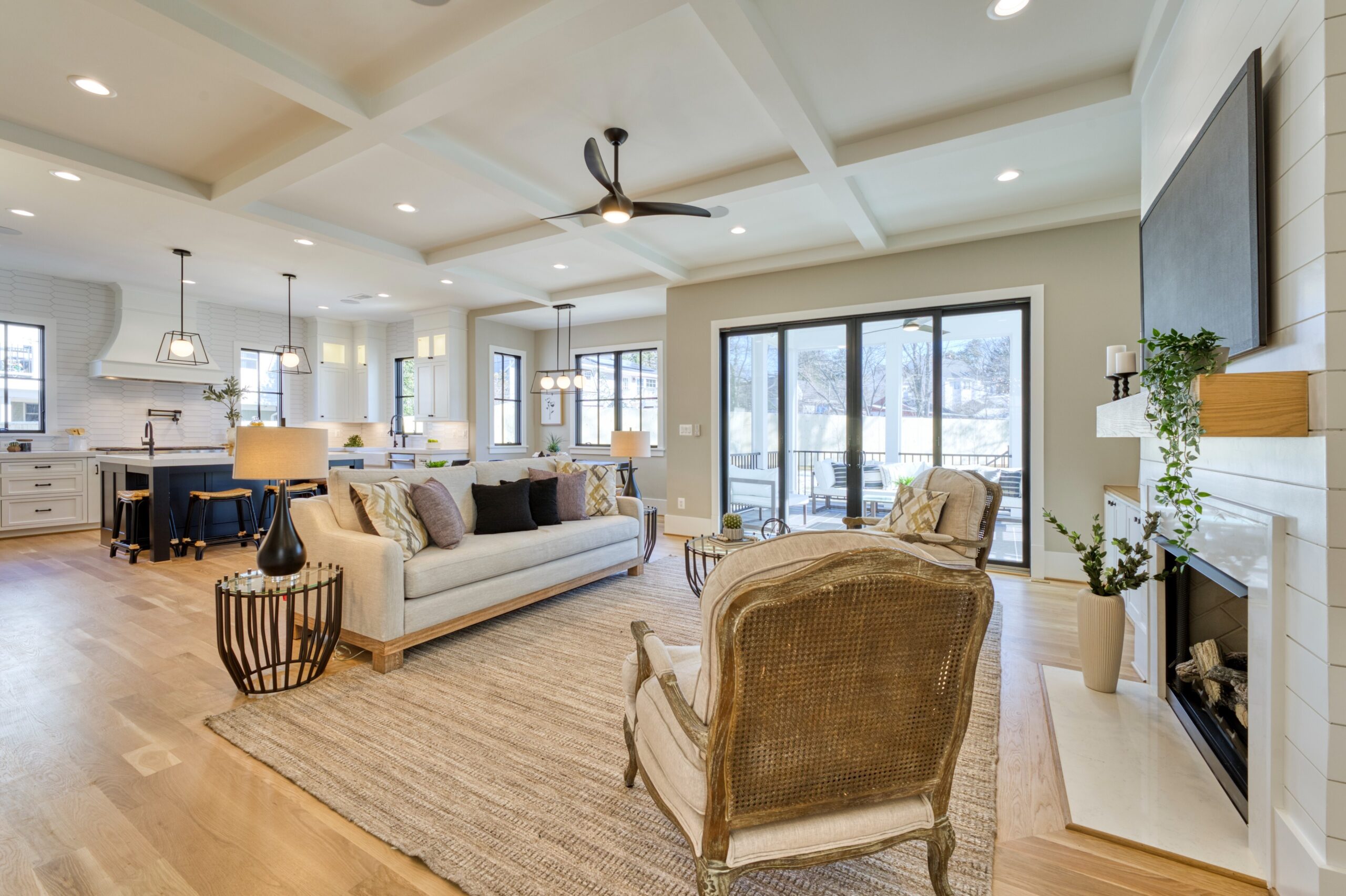 Professional interior photo of 1624 Dempsey St, McLean, VA - showing the main living space with coffered ceiling over the living room with the kitchen in the background