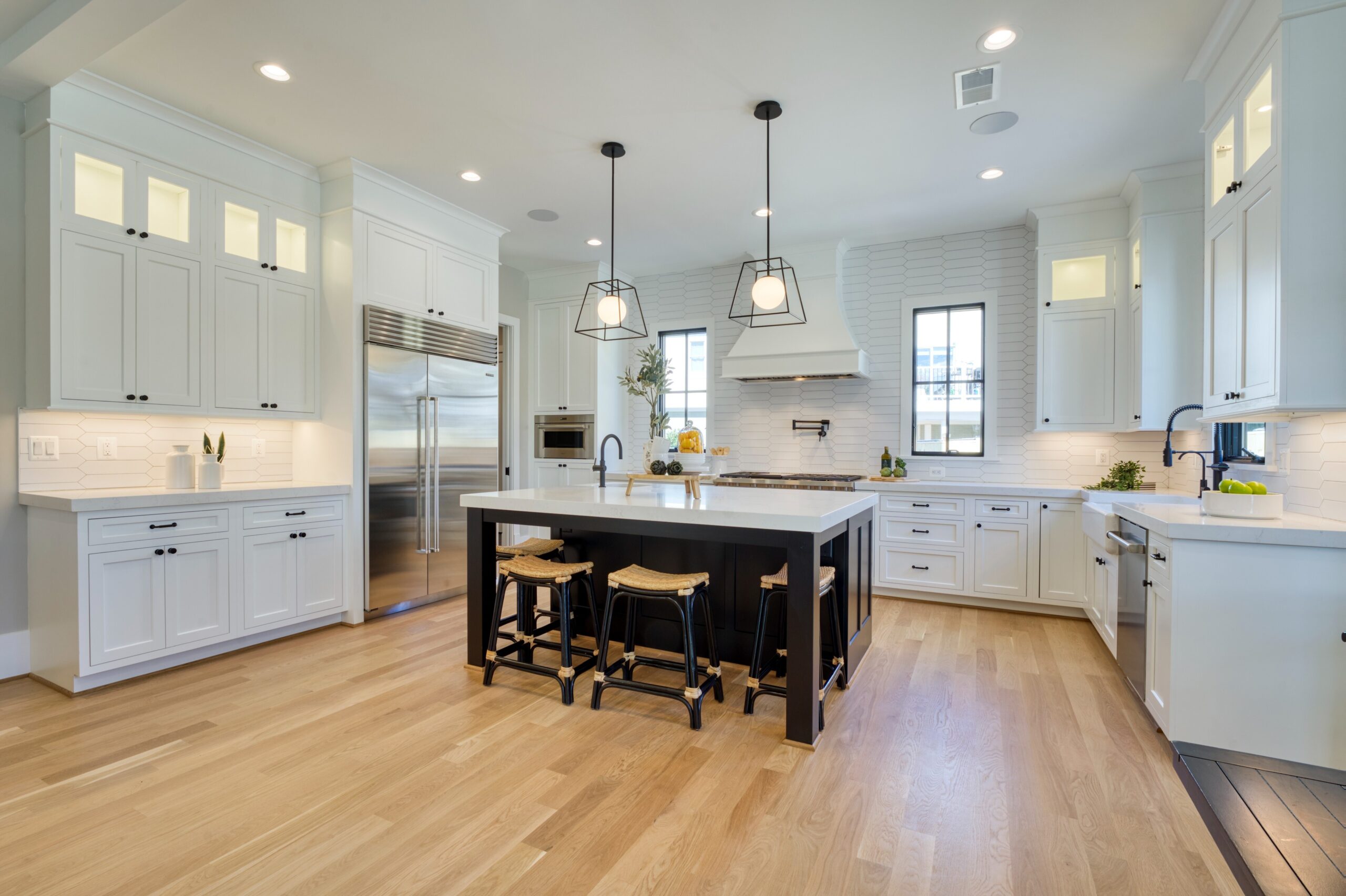 Professional interior photo of 1624 Dempsey St, McLean, VA - showing the white kitchen with large island and quartz countertops