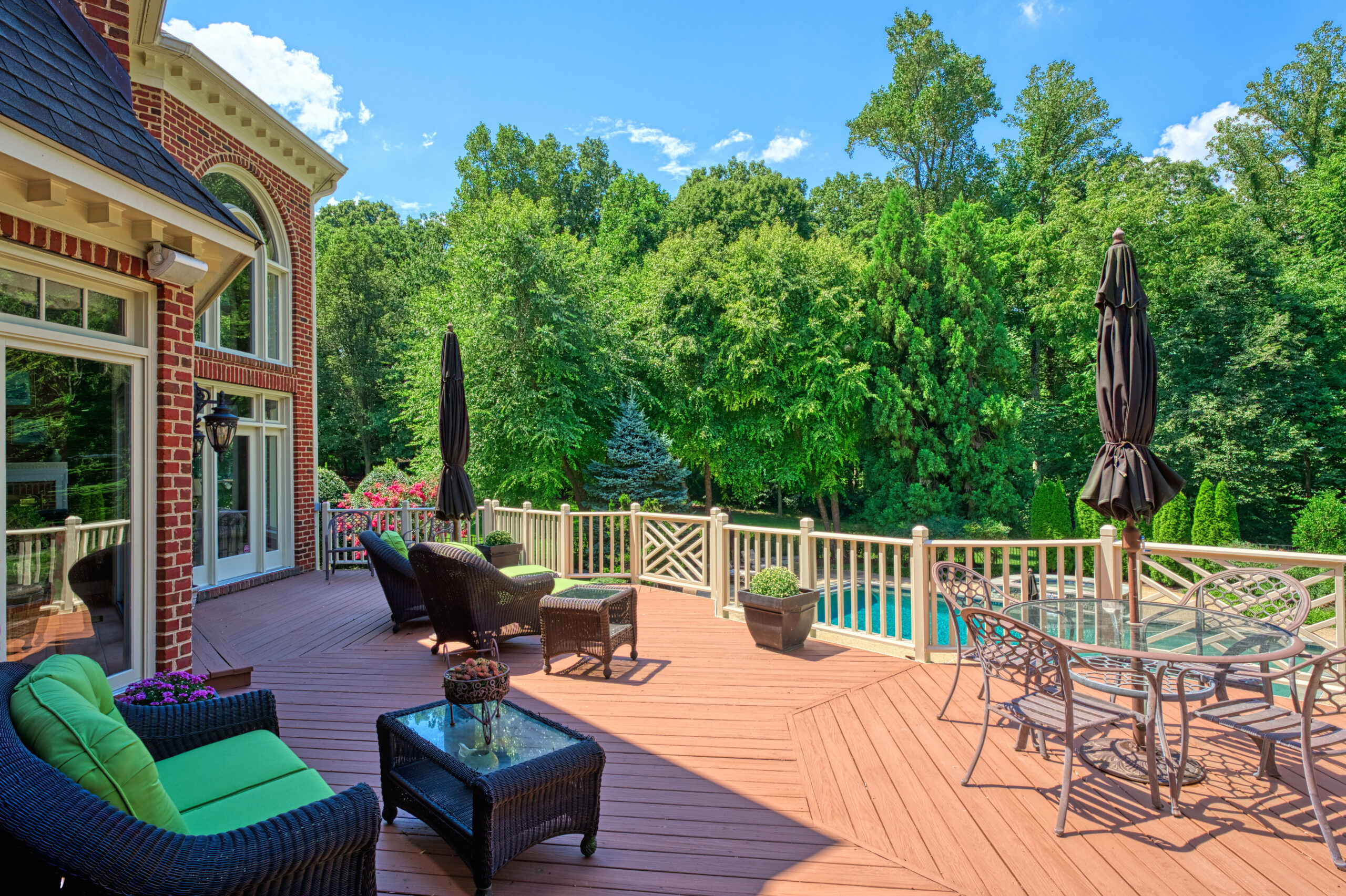 Professional exterior photo of 17087 Bold Venture Drive, Leesburg - showing the rear of the home from the large deck looking toward the pool
