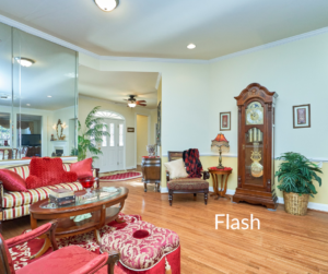 Professional Flash photo of a living room with mirrors, white walls and ceiling, and hardwood floors. Label "Flash" overlay in white