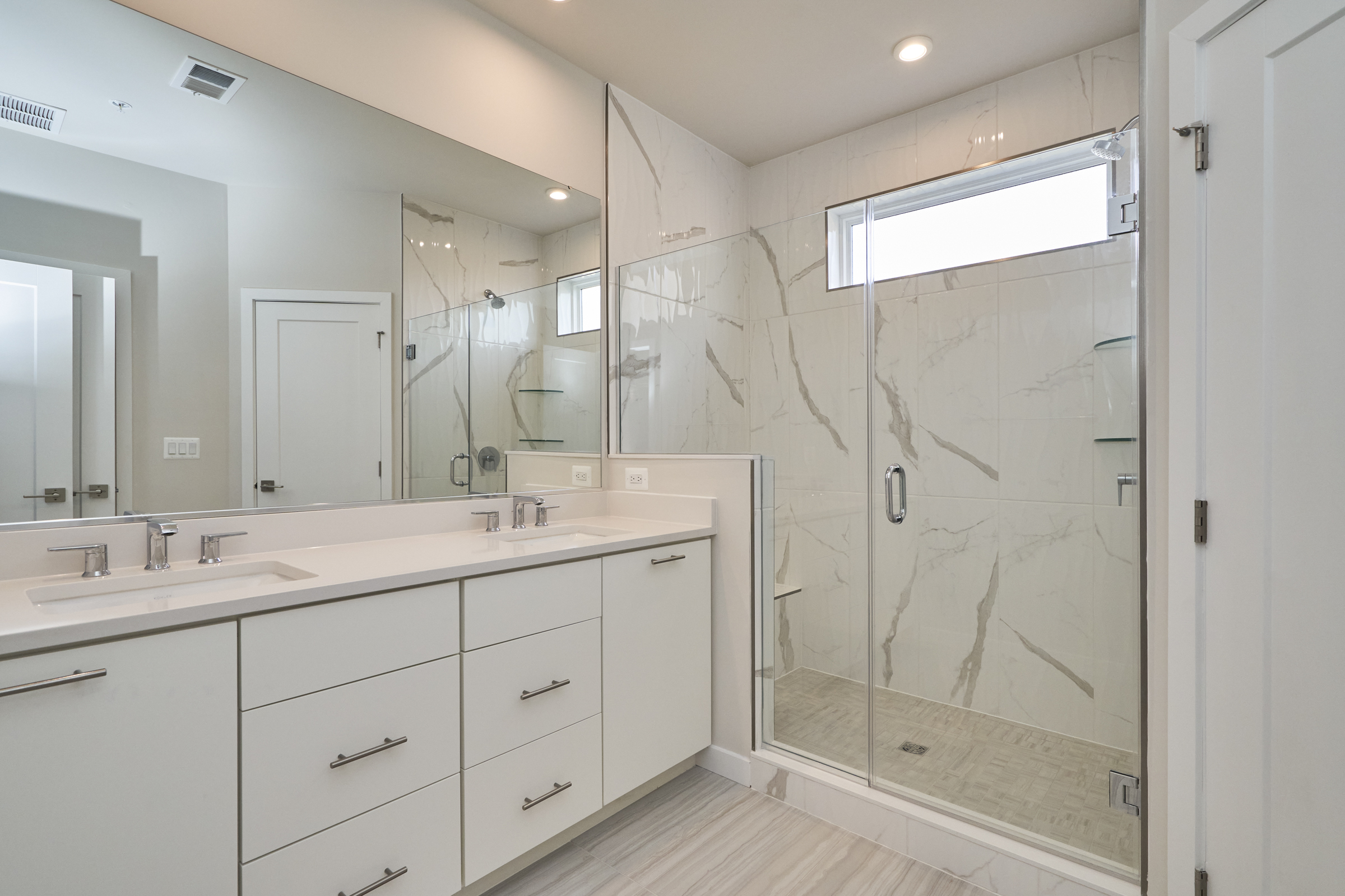 Interior professional photo of 43522 Centergate Drive - showing the primary bathroom with quartz countertops and zero entry shower