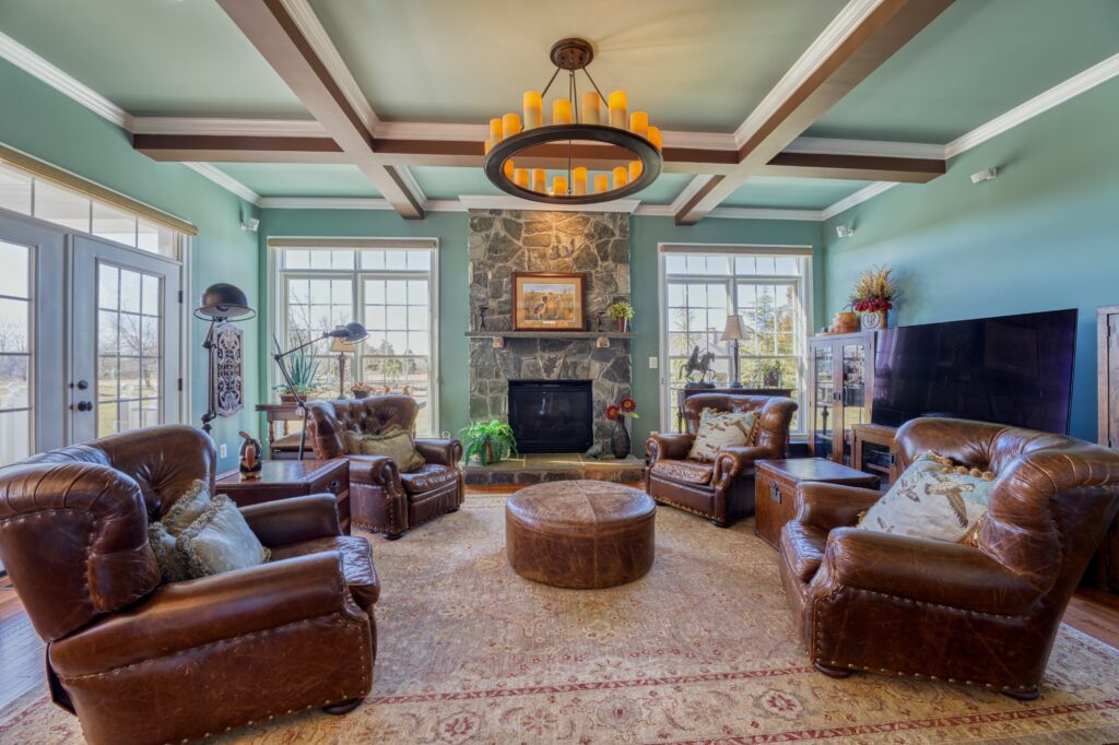 Professional Fusion photo of a living room with dark leather furniture and coffered ceiling