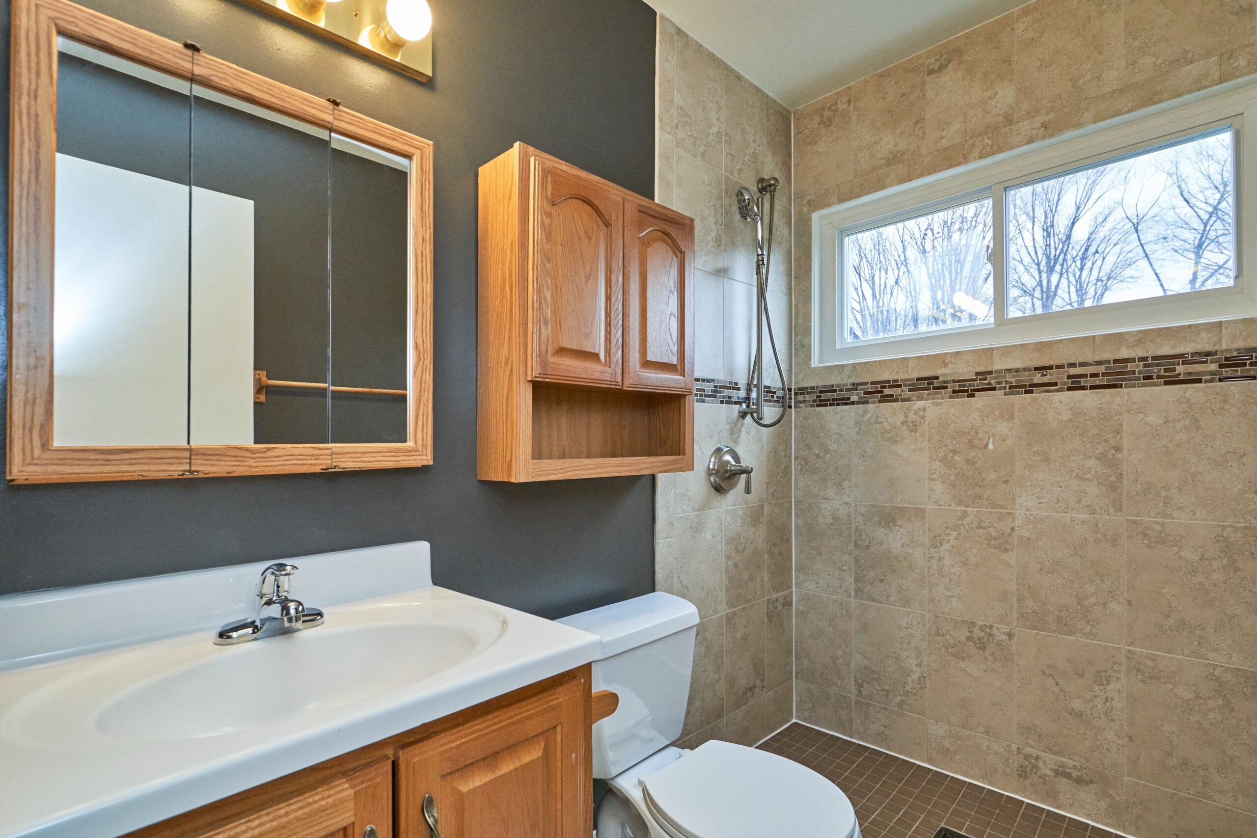 Professional interior photo of 3482 Mildred Drive in Falls Church virginia, showing one of the full bathrooms with large zero entry tile shower