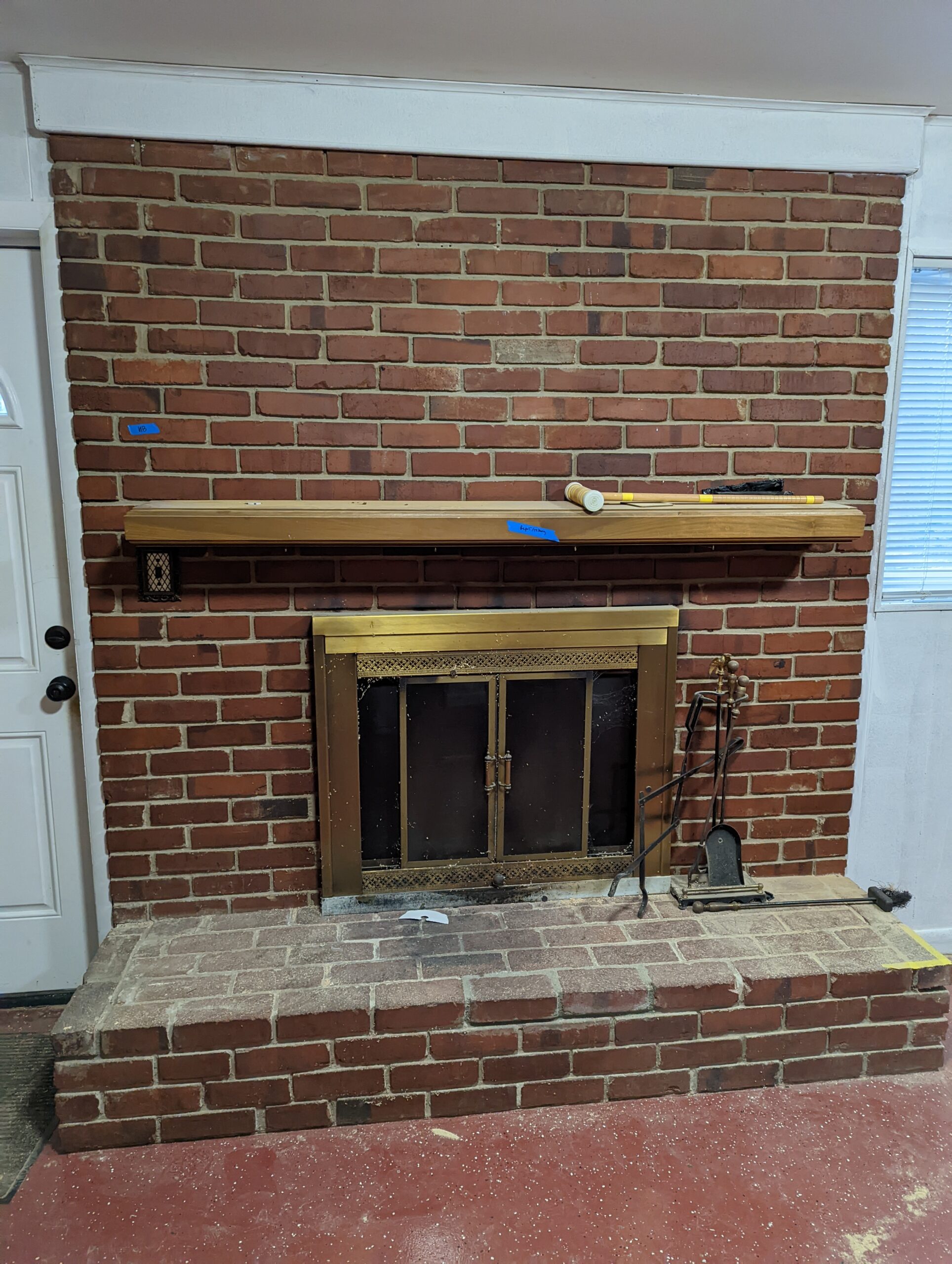 cellphone photo of 3482 Mildred Dr, Falls Church Virginia - showing the before photo of the basement fireplace