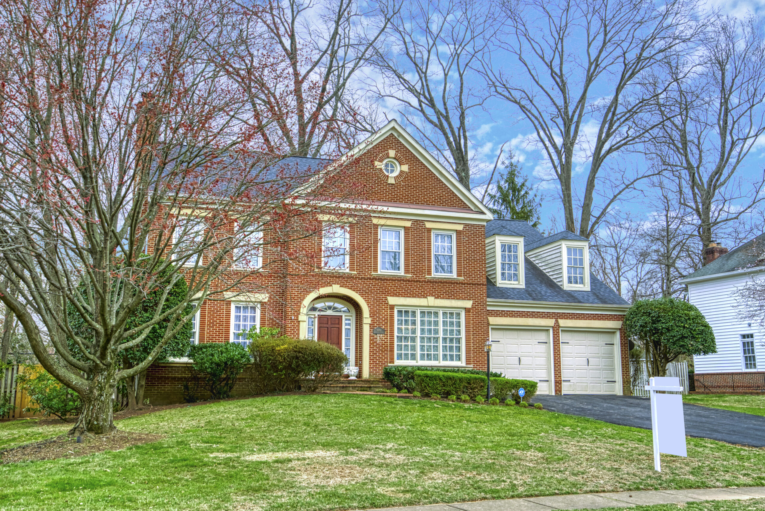 Professional exterior photo of 9701 Chilcott Manor Way - taken from the front left angle, all brick colonial with 2 car garage