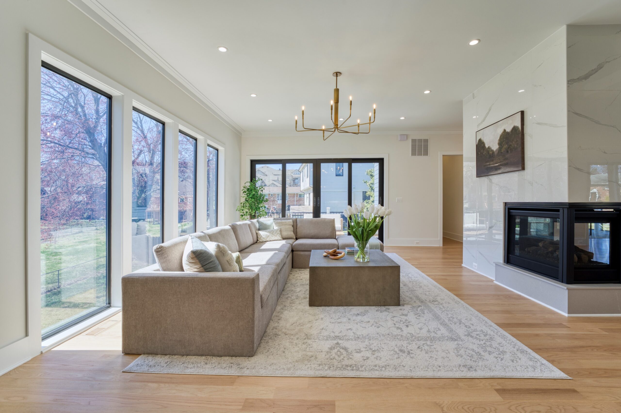 Professional interior photo of Custom New Home 1416 S Greenbrier St - showing the formal living room with large floor to ceiling windows and double-sided fireplace