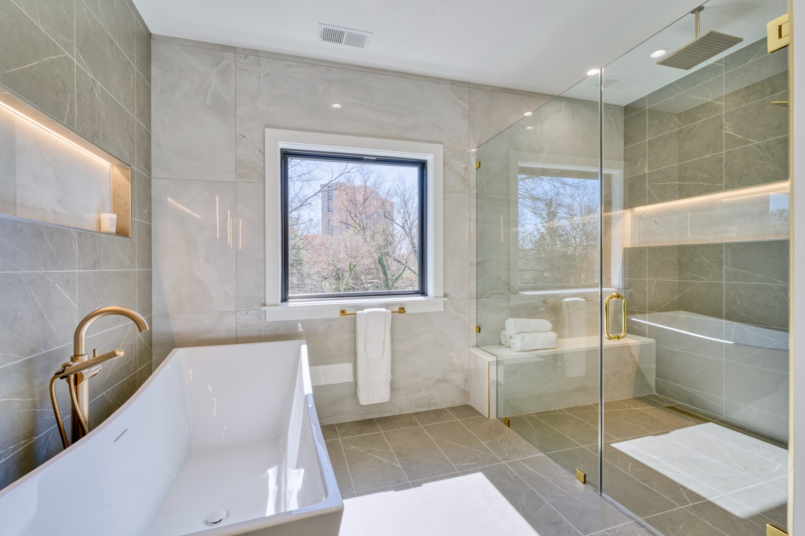 Professional interior photo of Custom New Home 1416 S Greenbrier St - showing the primary bathroom with soaking tub and large zero-entry shower with shower bench