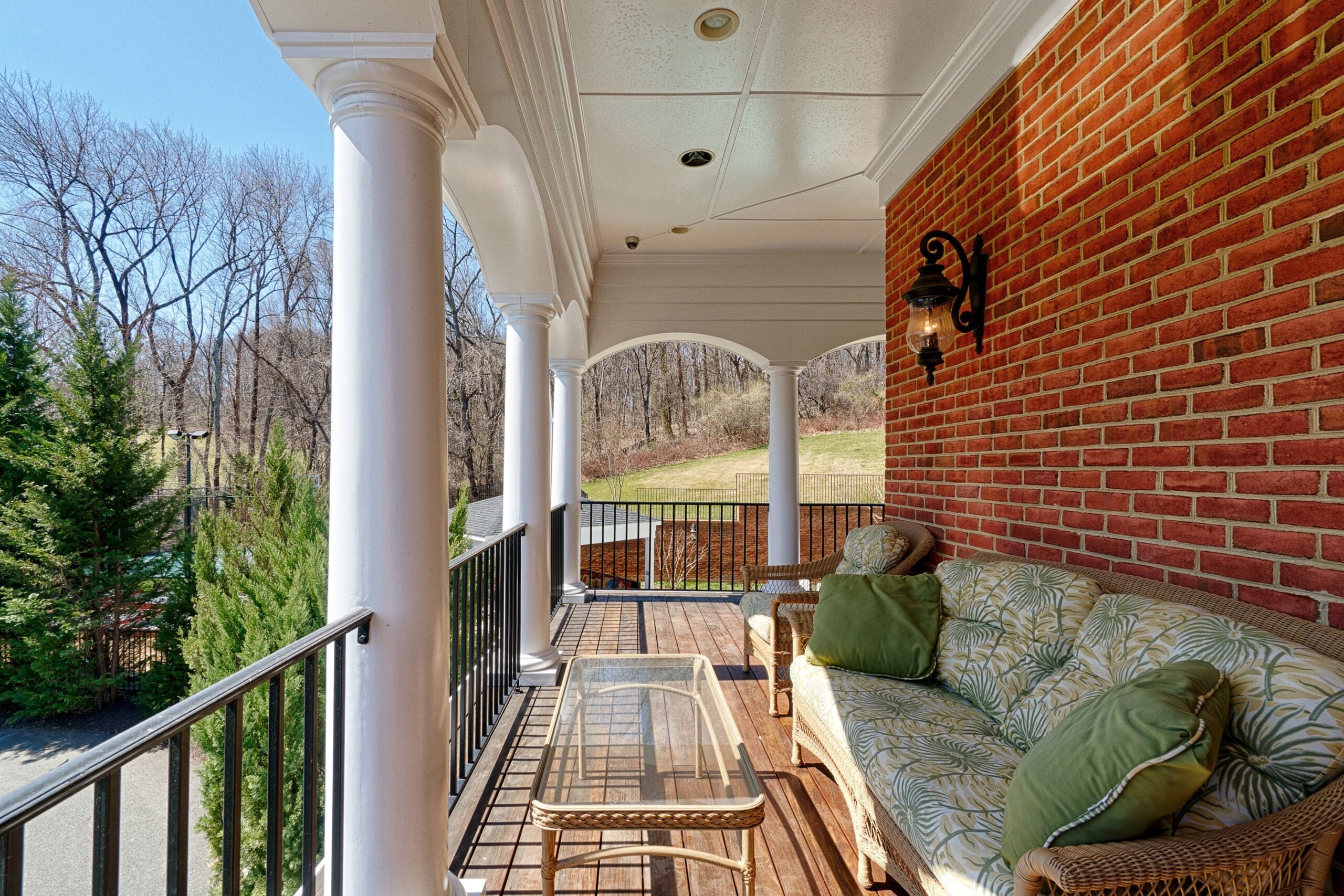 Exterior professional photo of 40573 Spectacular Bid Place - showing one of the balconies, brick side home with white columns and patio furniture
