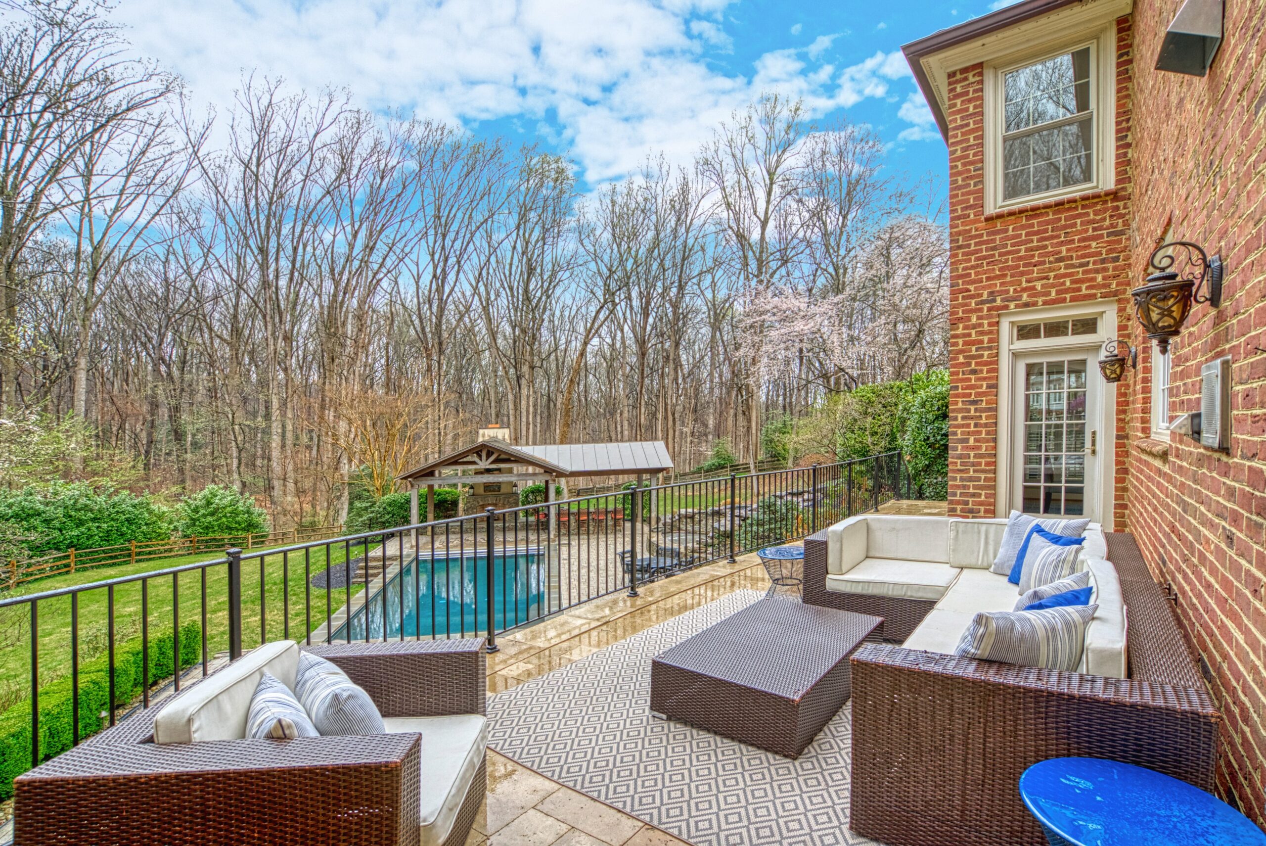 Professional exterior photo of 718 Potomac Knolls Dr - showing the rear deck looking out over the heated pool