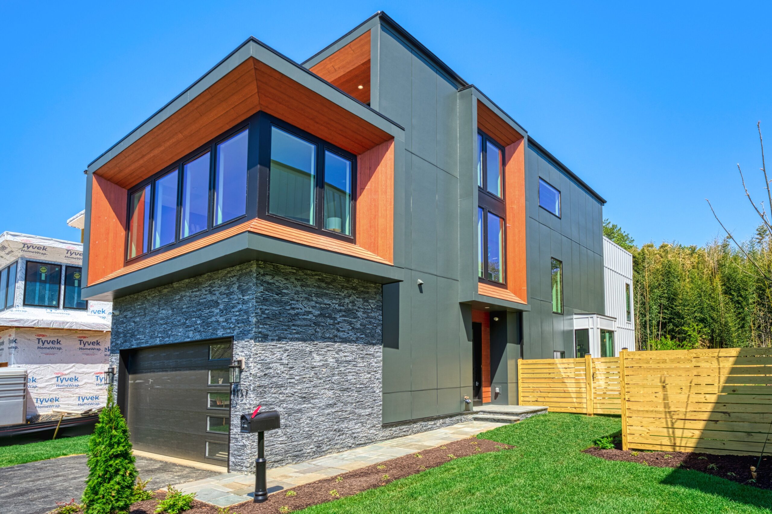 Professional exterior photo of 1137 Buchanan St in McLean, VA - showing the right side view of a brand new construction modern home with fenced in backyard