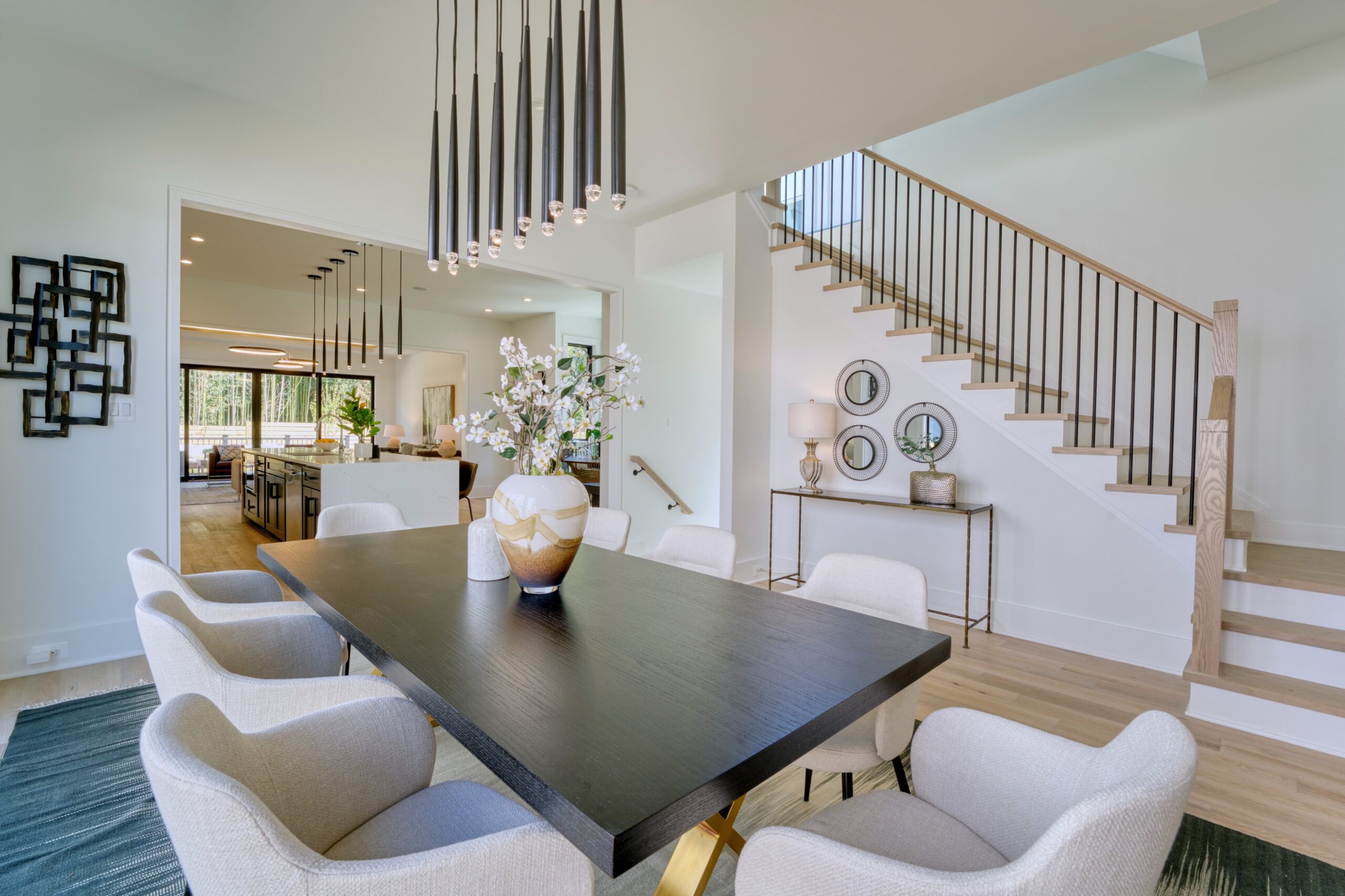 Professional interior photo of 1137 Buchanan St in McLean, VA - showing the formal dining area at the front of the home next to the staircase to the upper level and kitchen visible in the background