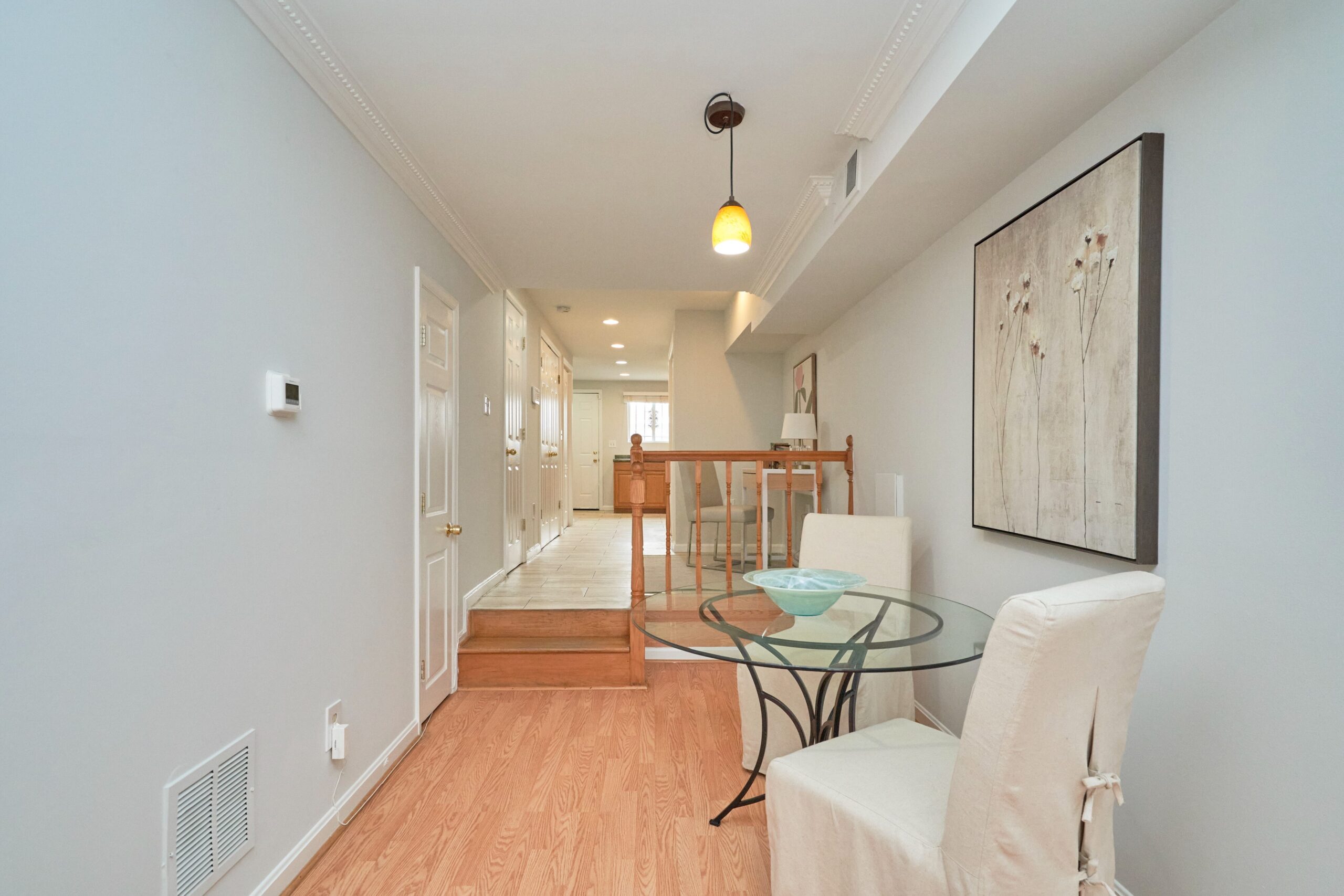 Professional interior photo of 1313 K Street SE, Washington, DC - showing the breakfast/dining space just before 2 steps up to an office space before the kitchen
