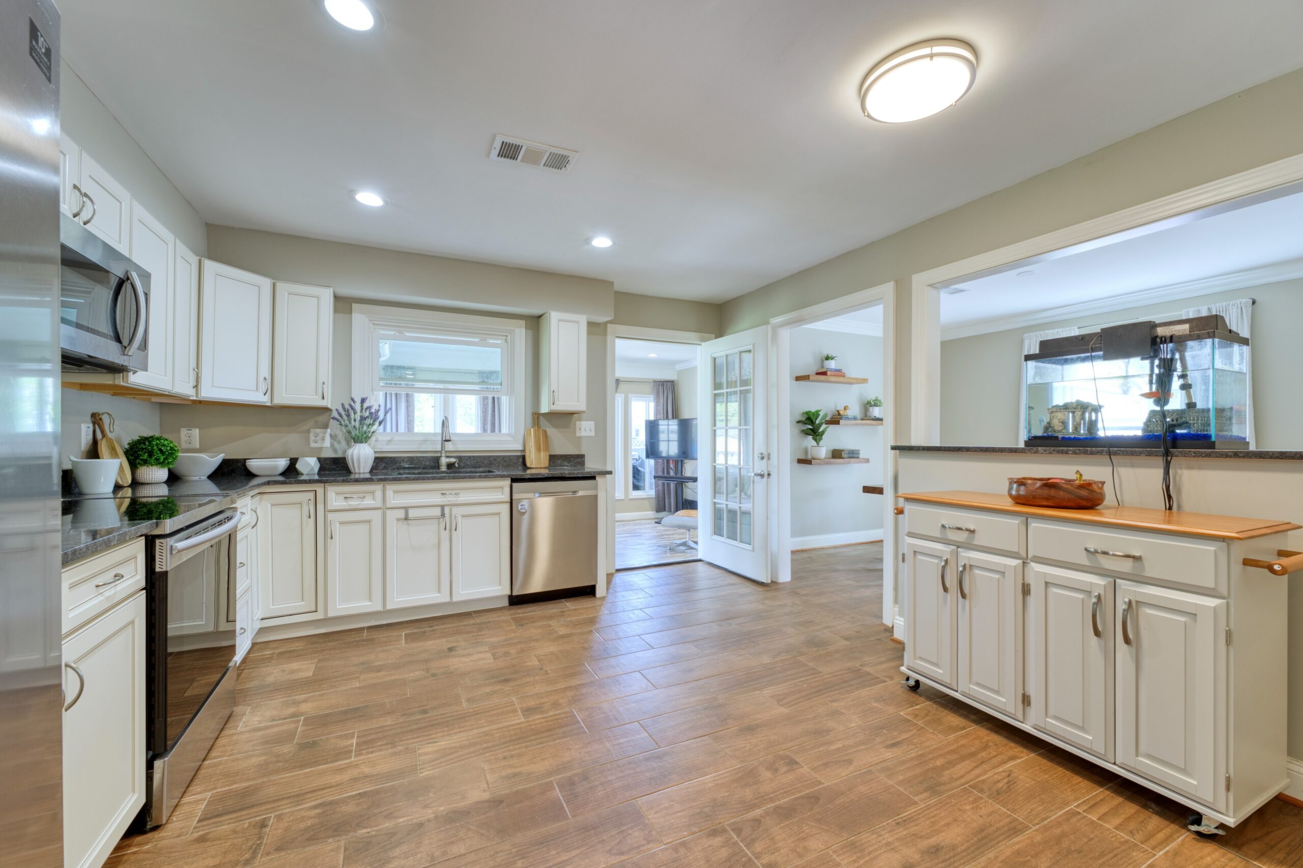 professional interior photo of 102 S Harrison Road, Sterling, VA - showing the remodeled kitchen with new white cabinets, stainless appliances and dark granite counters