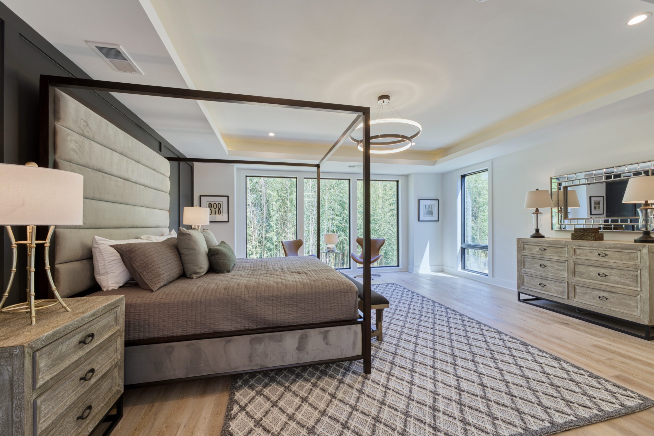 Professional interior photo of 1137 Buchanan St in McLean, VA - showing the primary bedroom with trey ceiling, large windows to the woods