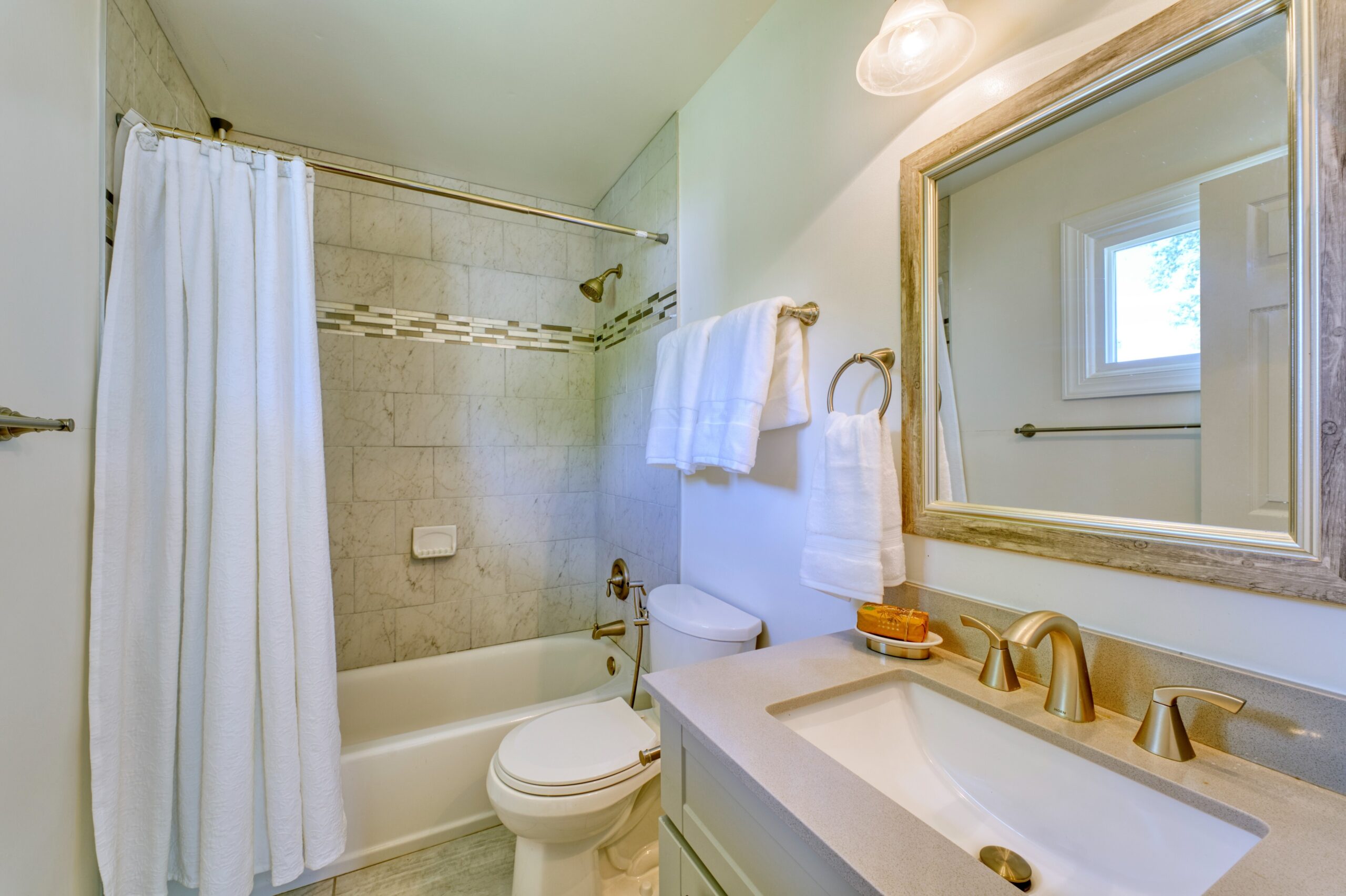 professional interior photo of 102 S Harrison Road, Sterling, VA - showing a full bathroom with stone shower